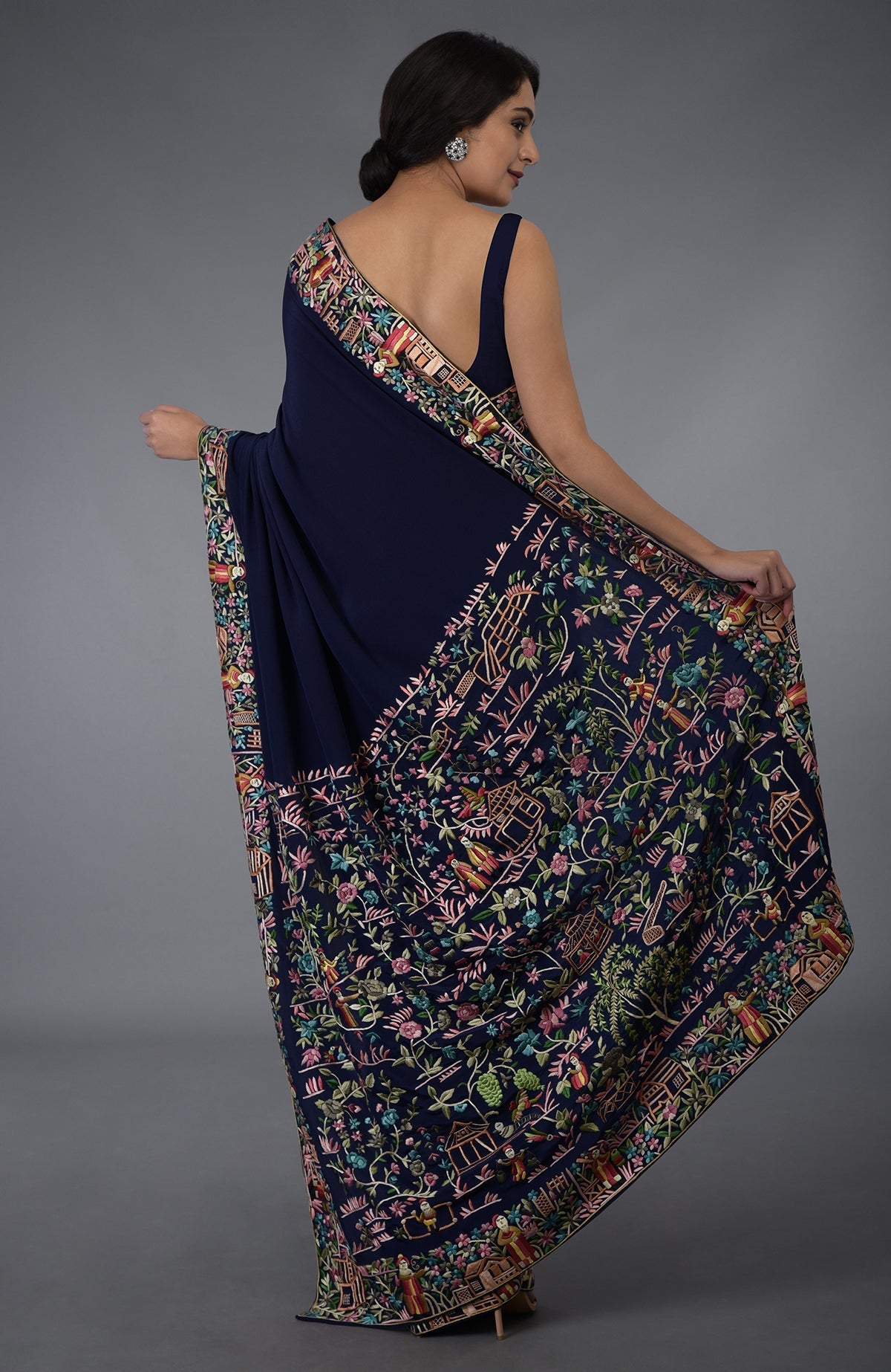 Midnight blue Parsi Gara hand-embroidered saree with vibrant floral and scenic patterns.