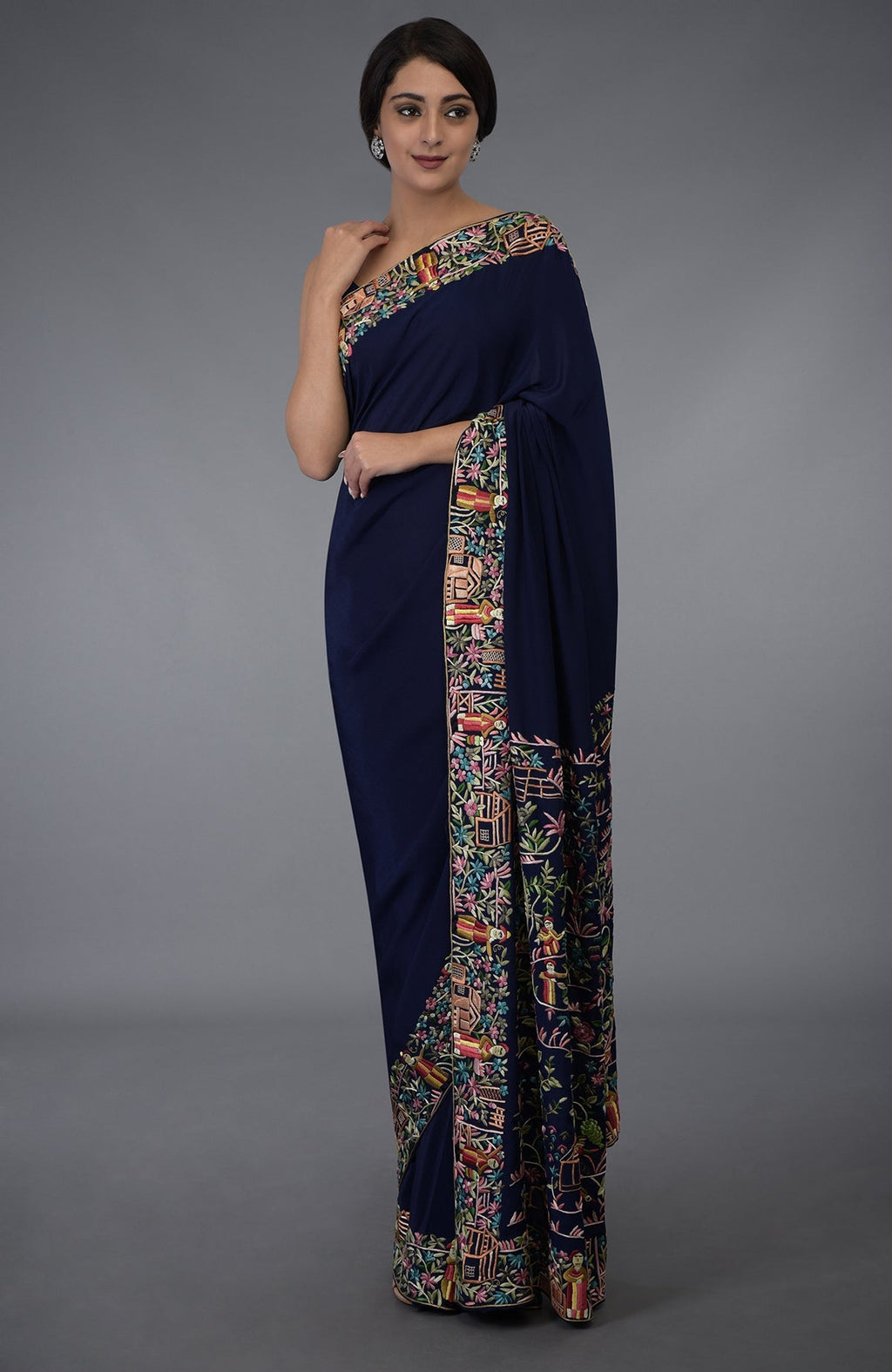 Midnight blue Parsi Gara hand-embroidered saree with vibrant floral and figural motifs.