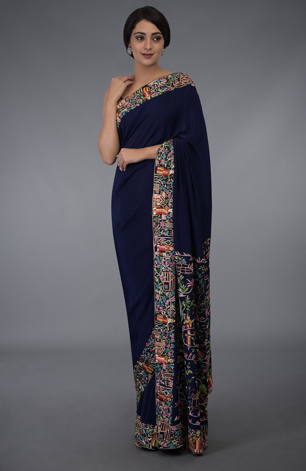Midnight blue Parsi Gara hand-embroidered saree with vibrant floral and figural motifs.