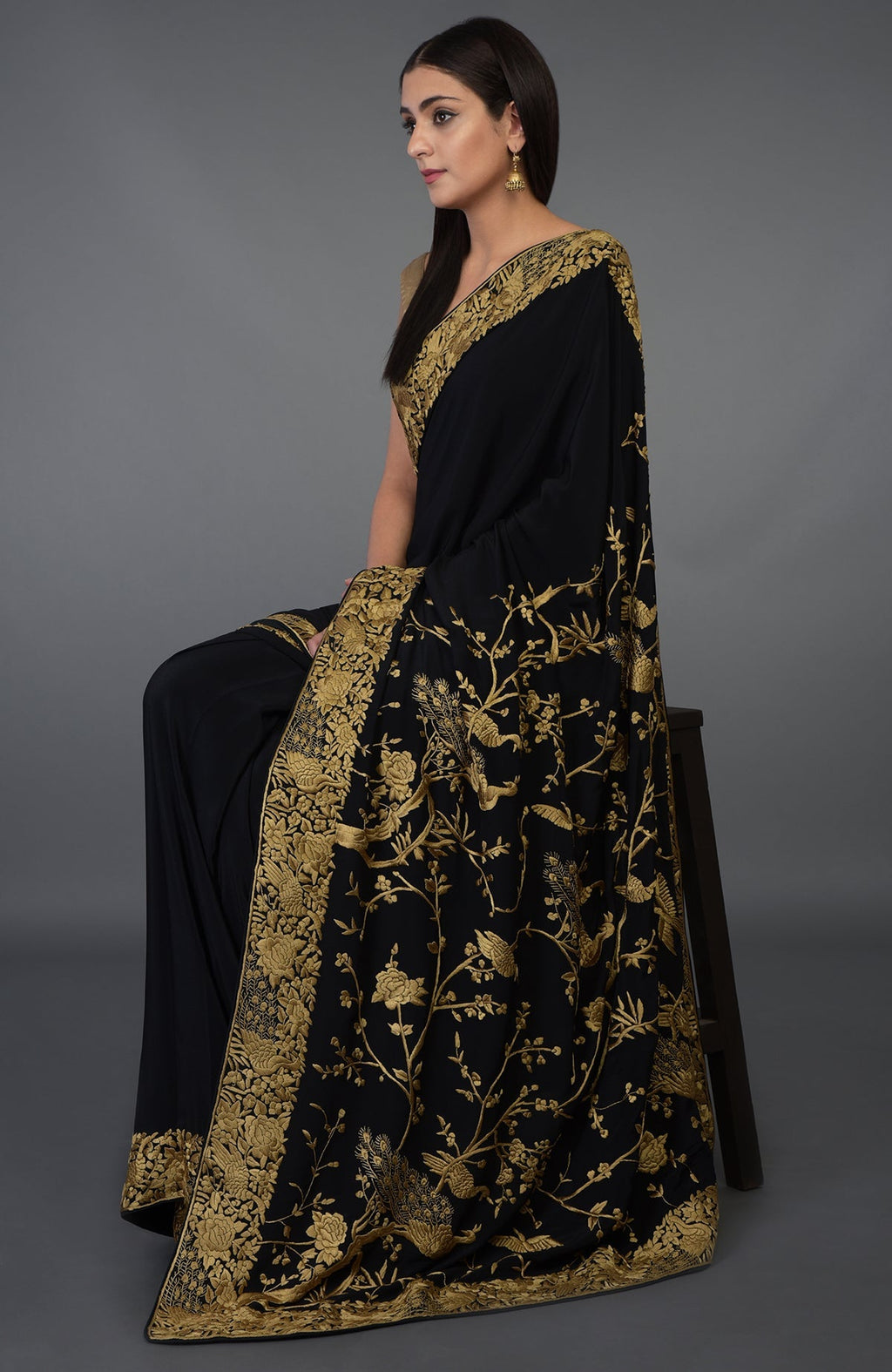 Black-beige gold Parsi Gara hand embroidered saree with floral and peacock motifs.