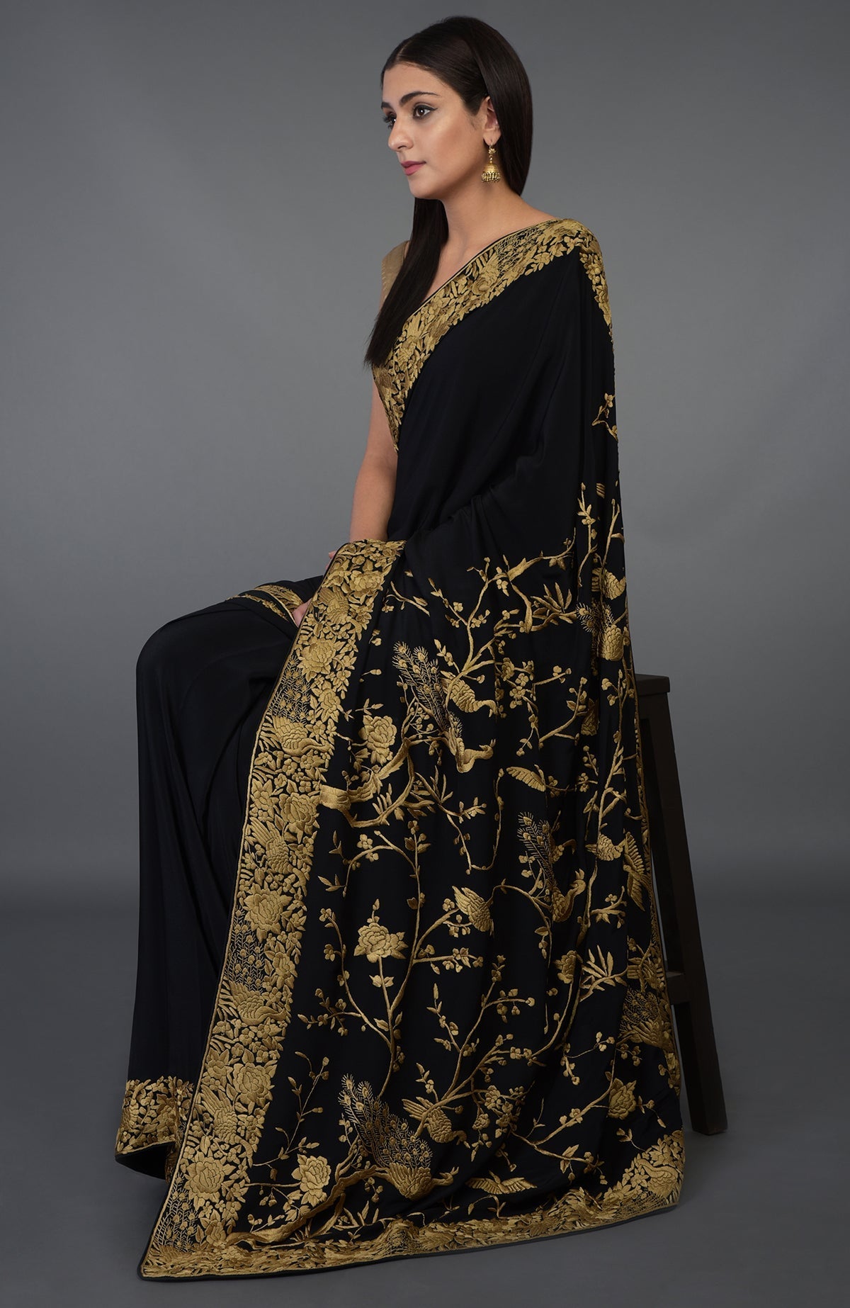 Black-beige gold Parsi Gara hand embroidered saree with floral and peacock motifs.
