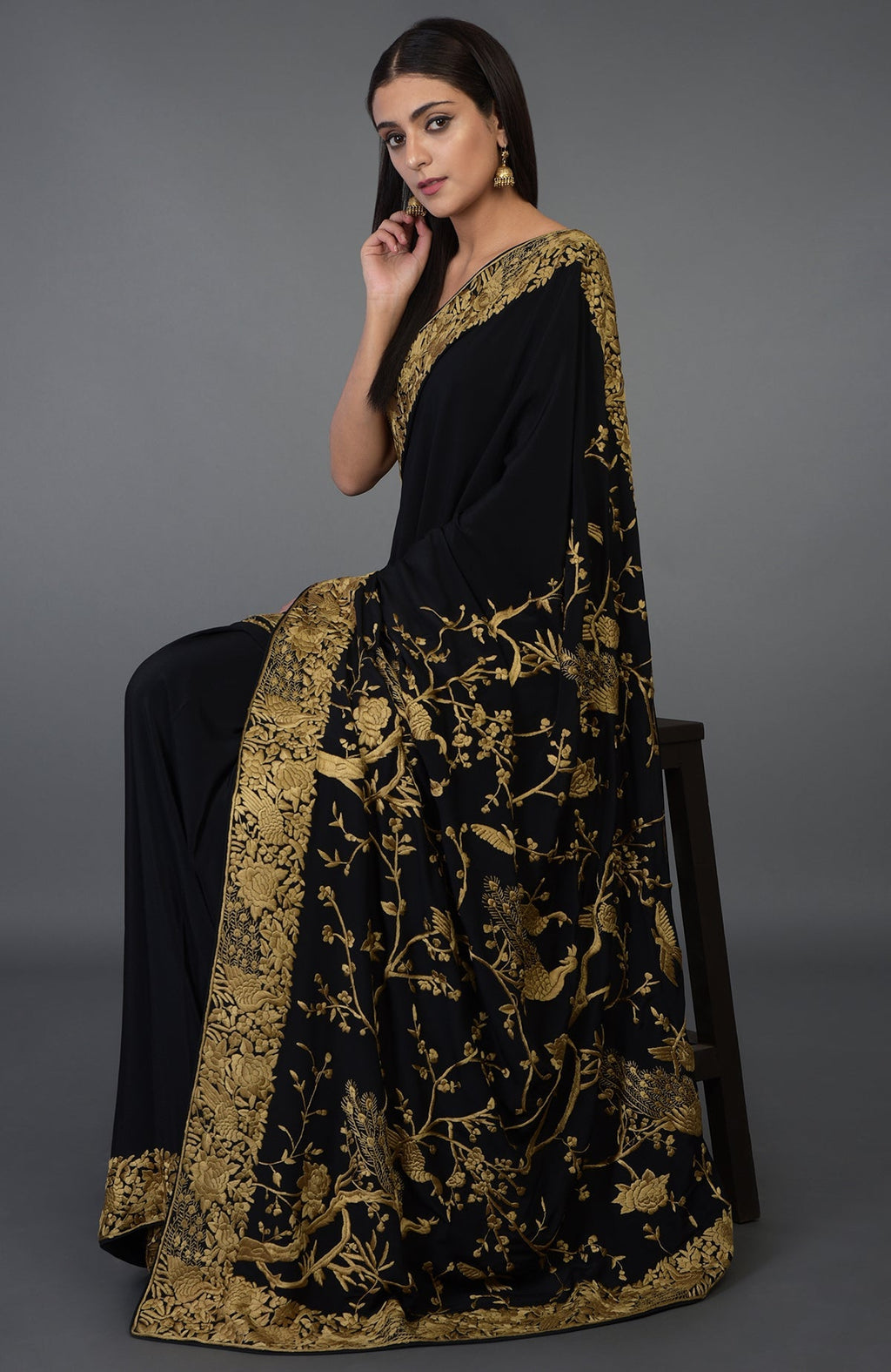 Black-beige gold Parsi Gara hand-embroidered saree with floral and peacock motifs.