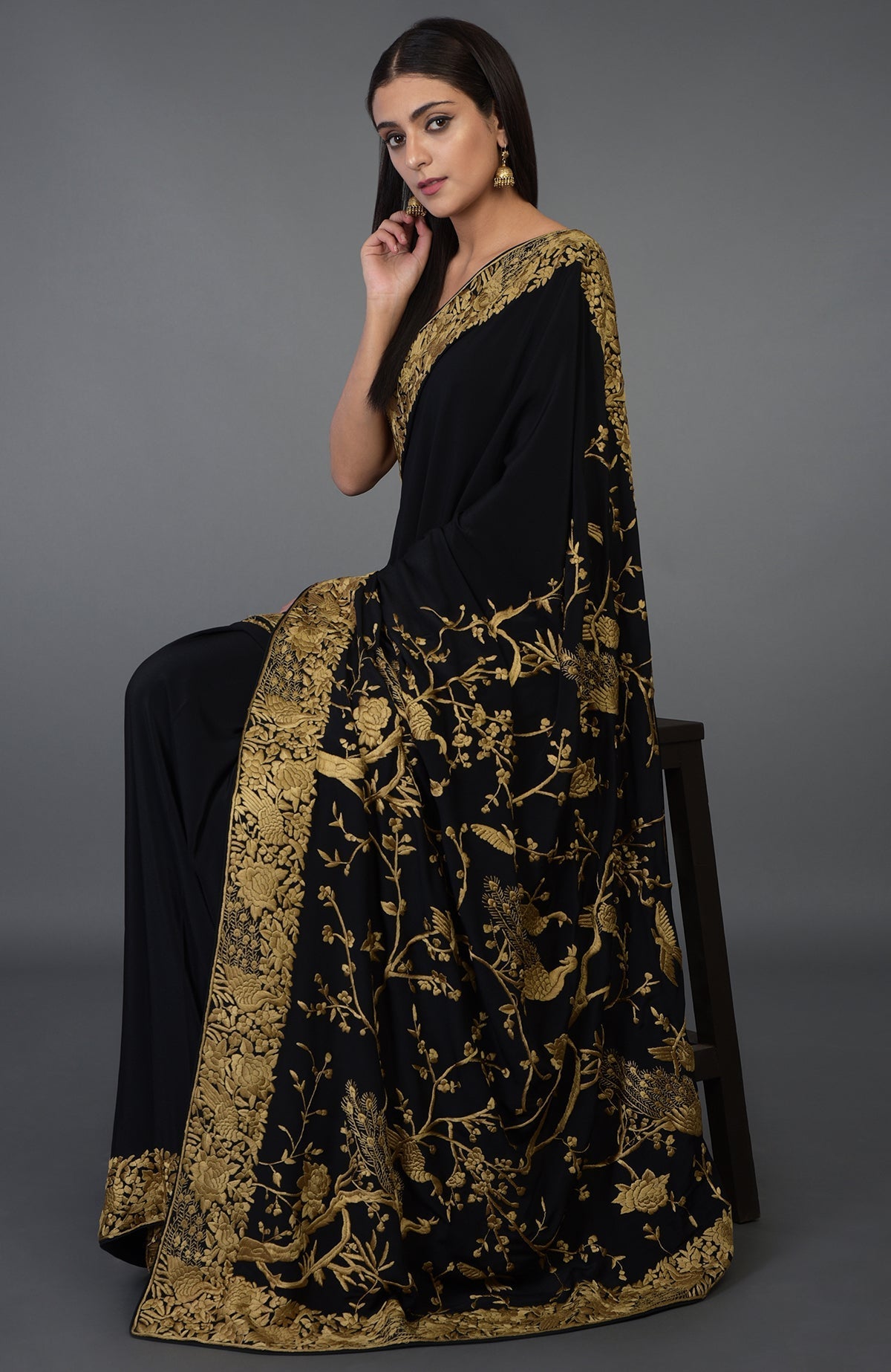 Black-beige gold Parsi Gara hand-embroidered saree with floral and peacock motifs.