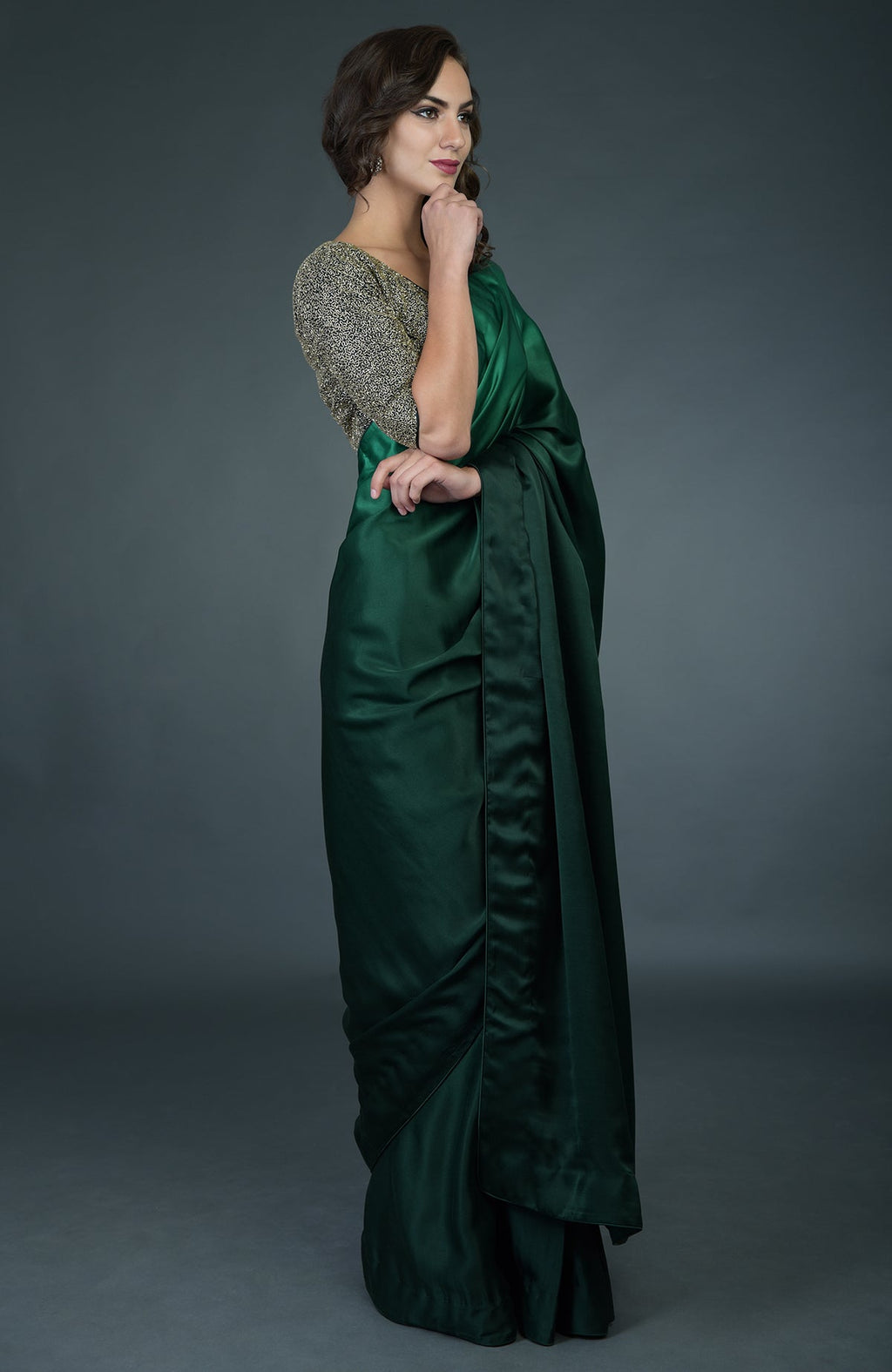 Bottle green ombre saree with a gold zardozi work blouse.