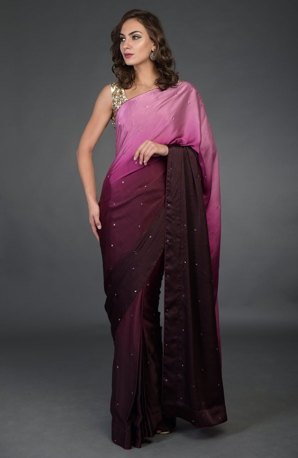 A woman models a wine-pink ombre satin silk saree with sequin embroidery.