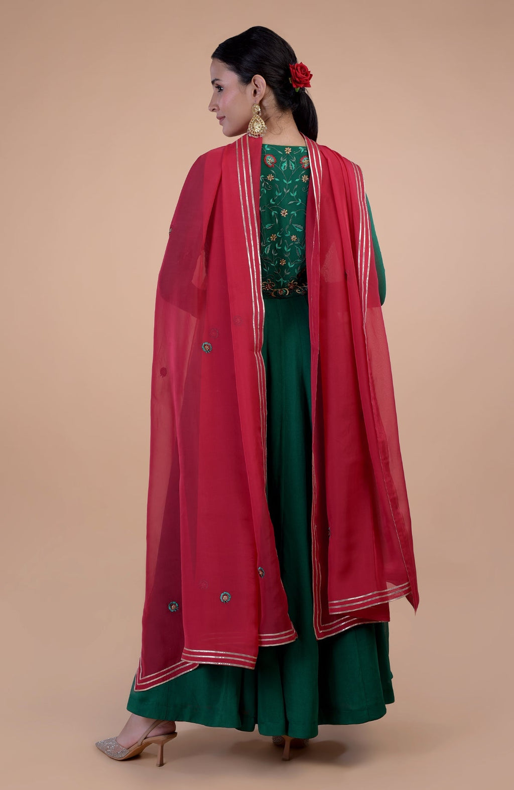 Emerald green Anarkali set with red resham and zardozi embroidery.