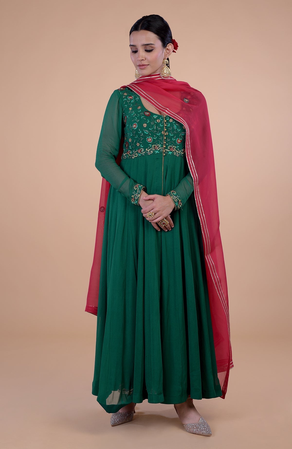 Emerald green Anarkali set with red resham and zardozi embroidery.
