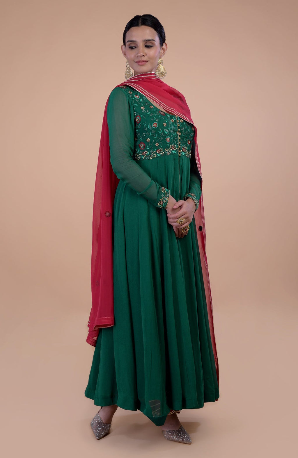 Emerald green anarkali set with red resham and zardozi embroidery.