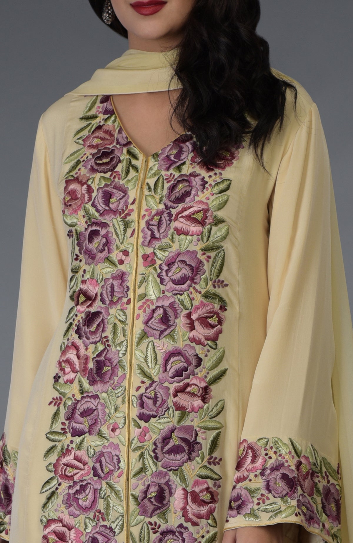 Lemon chiffon Parsi Gara embroidered suit with purple and pink floral patterns.