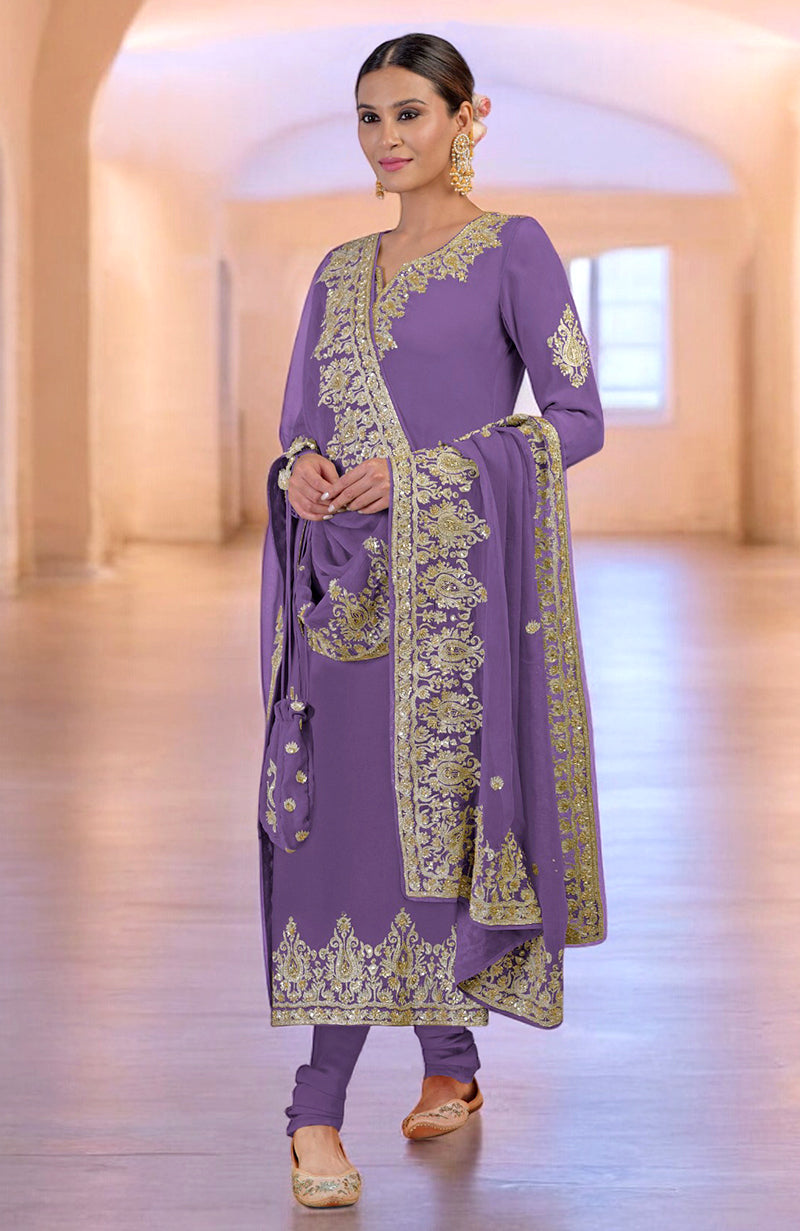 A woman models a bright rose gold Kashmiri Tilla and Zardozi hand-embroidered kurta set.
