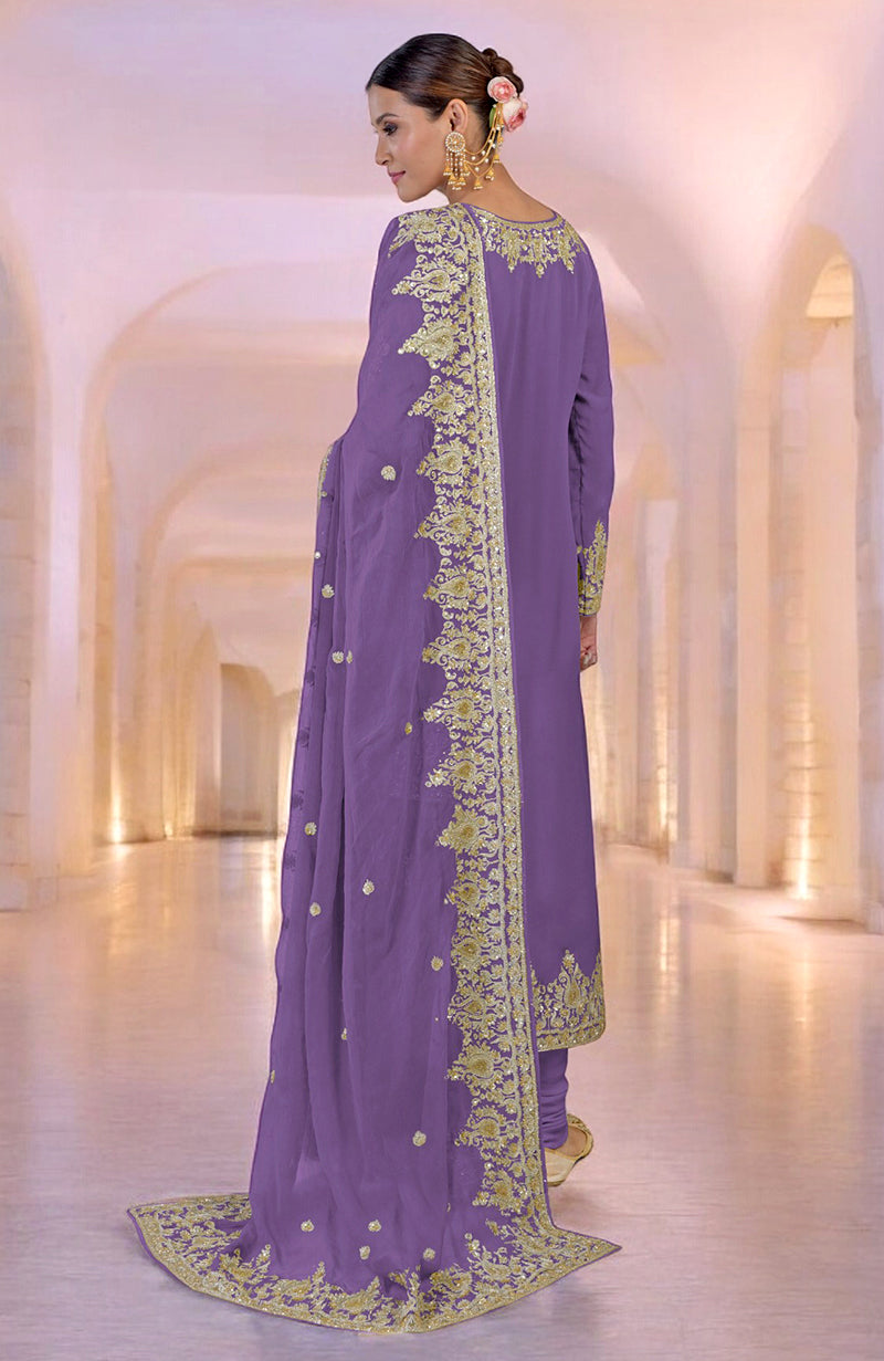 A woman models an amethyst orchid kurta set with gold Kashmiri tilla and zardozi embroidery.