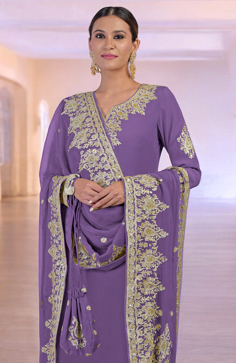 A woman models an amethyst orchid kurta set with gold embroidery and a matching potli bag.