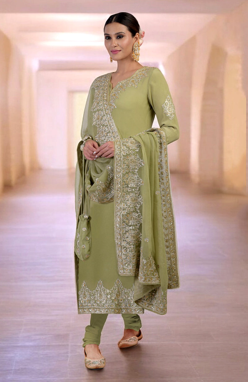 A woman models a green kurta set with gold embroidery and a matching potli bag.
