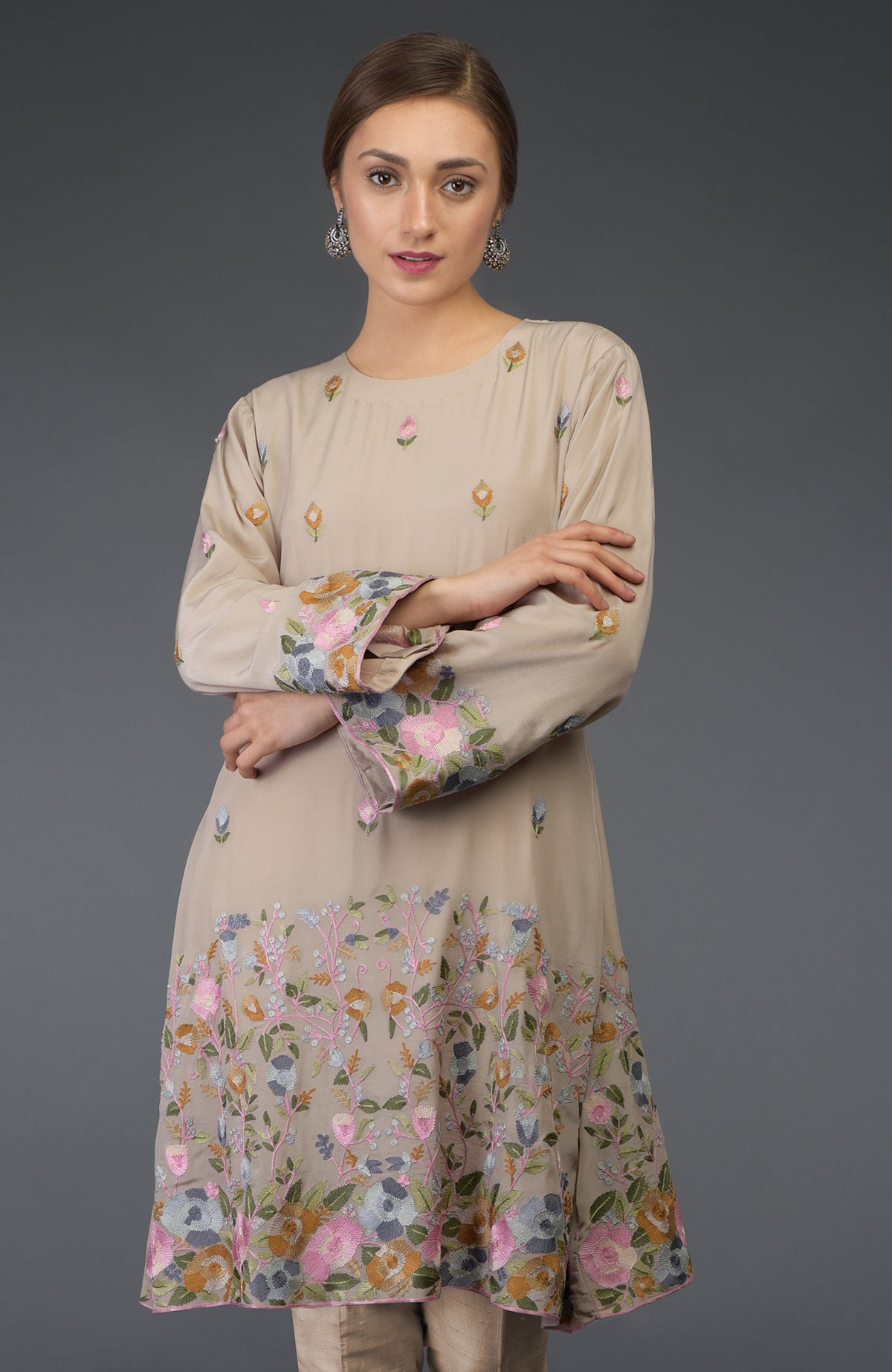 Beige Parsi embroidered tunic suit with floral patterns and bell sleeves.