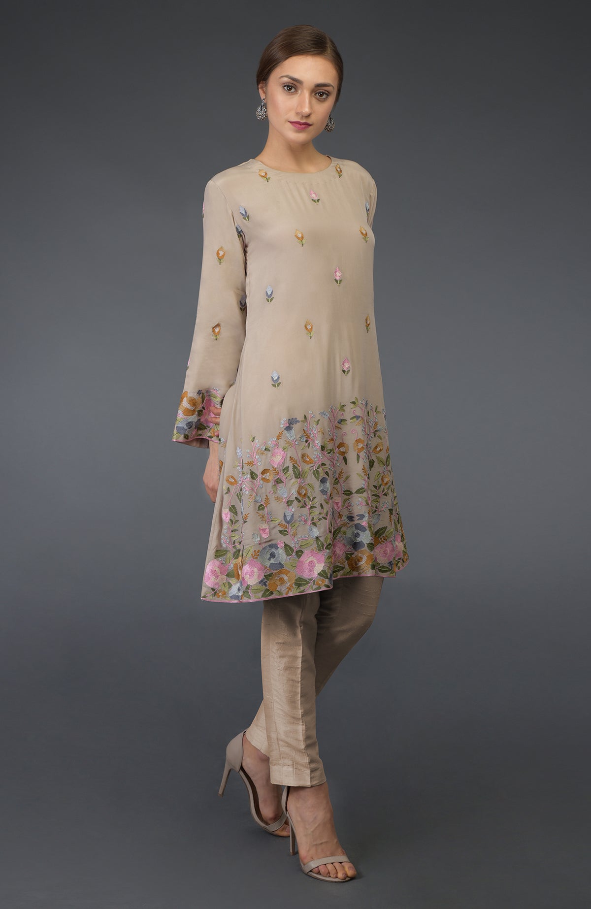Beige Parsi embroidered tunic suit with floral embroidery and matching pants.