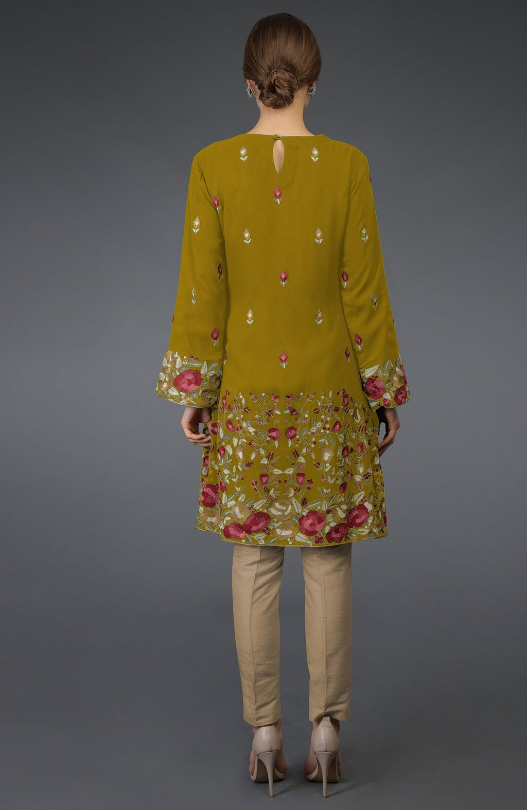 Mustard Parsi embroidered tunic suit with beige pants and nude heels.