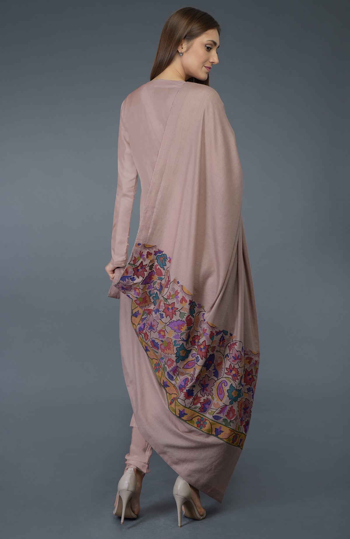 A woman models a dusty rose suit with a Kani art embroidered dupatta.