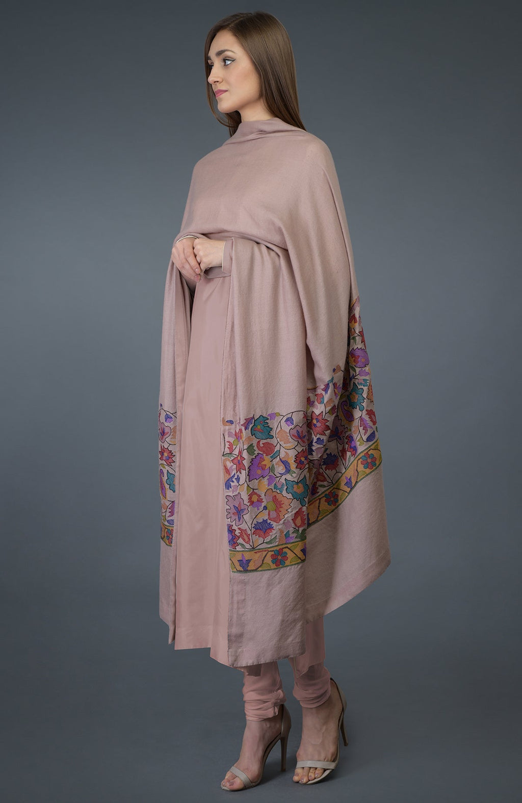 A woman models a dusty rose suit with a matching embroidered dupatta.