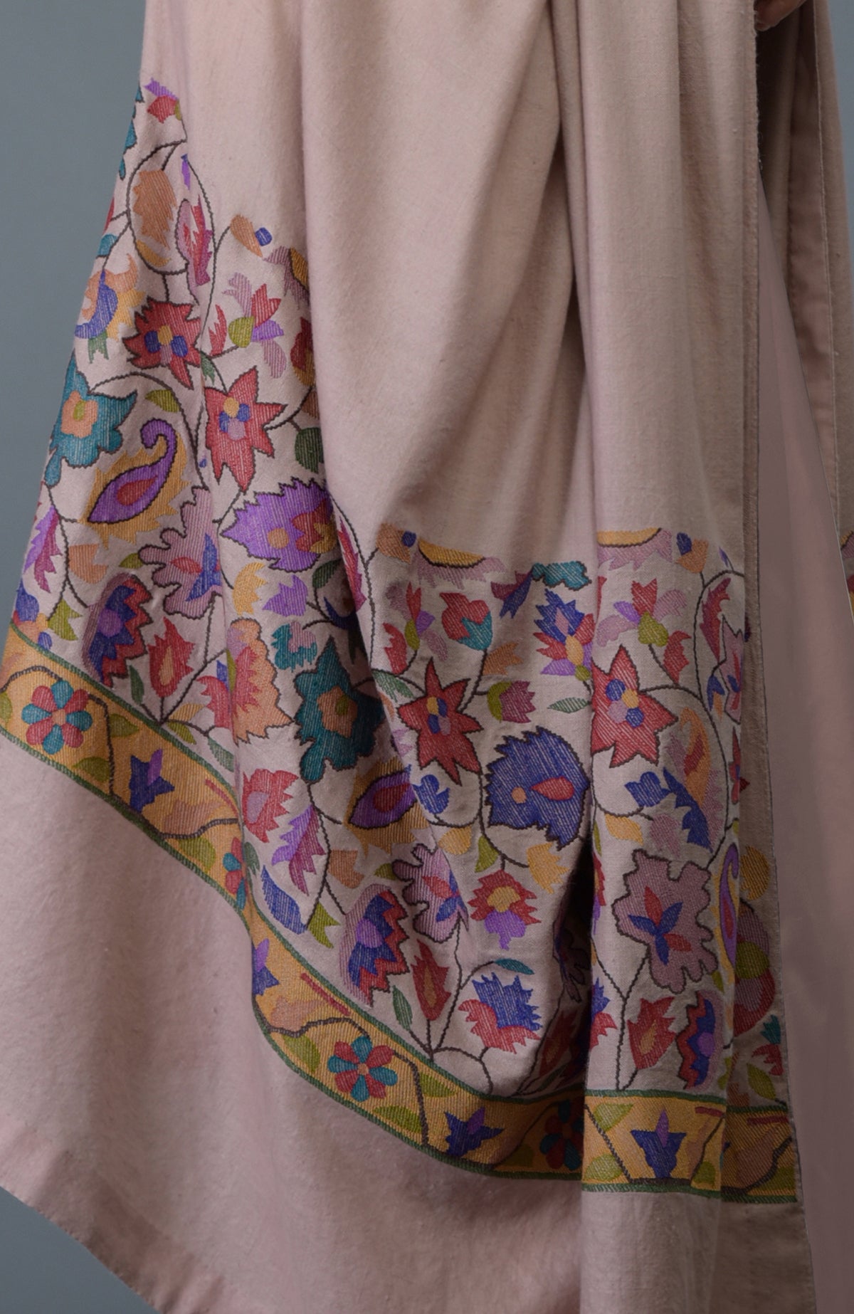 A dusty rose dupatta with colorful floral and paisley embroidery along the borders.
