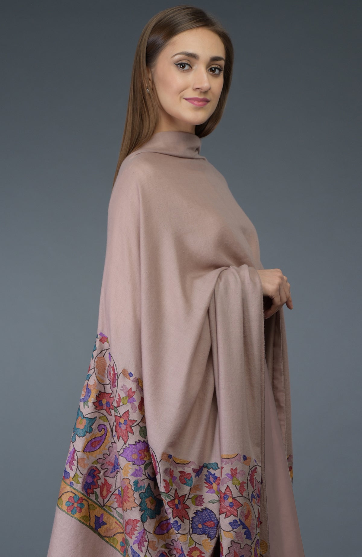 A woman models a dusty rose dupatta with colorful floral embroidery.