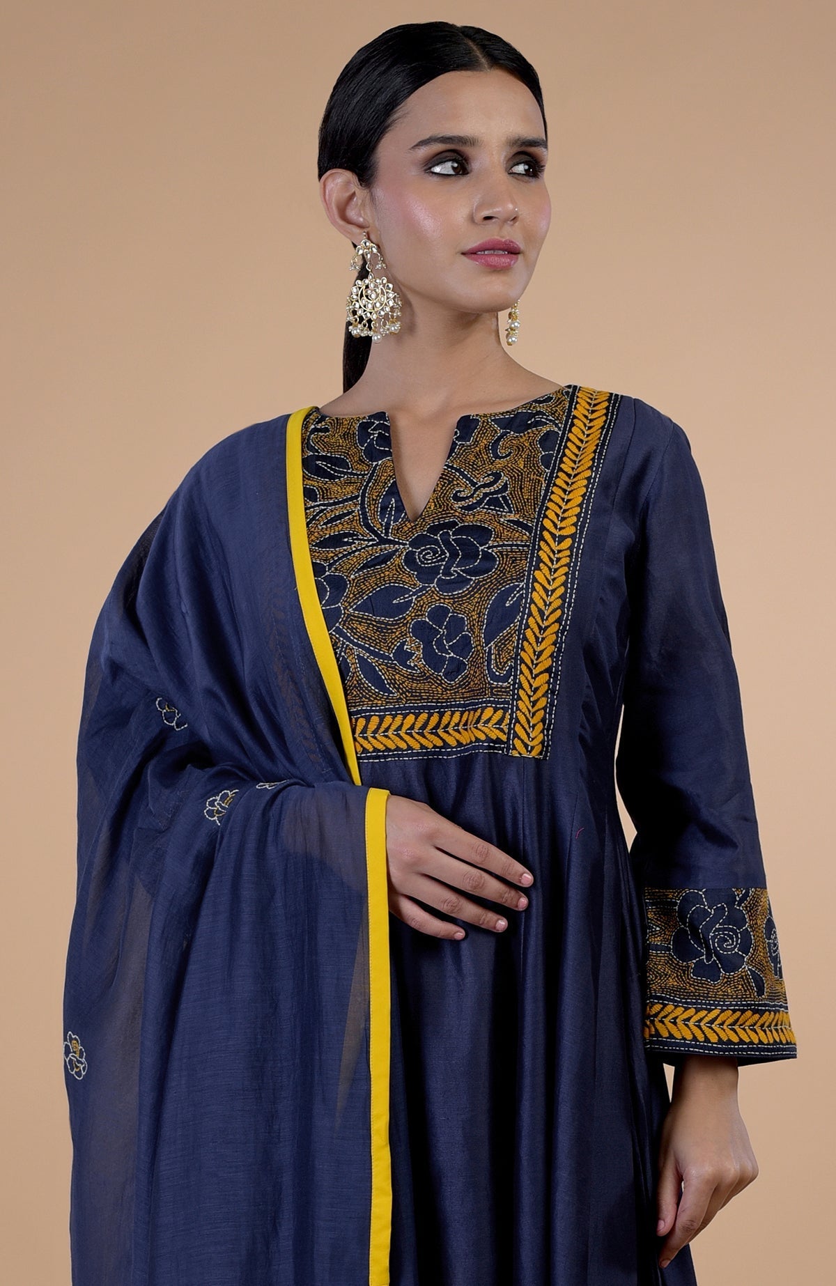 Navy blue Kantha hand-embroidered kalidaar kurta set with a yellow dupatta.