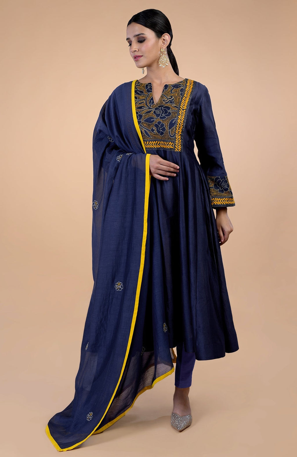 Navy blue Kantha hand-embroidered kalidaar kurta set with a yellow-piped dupatta.