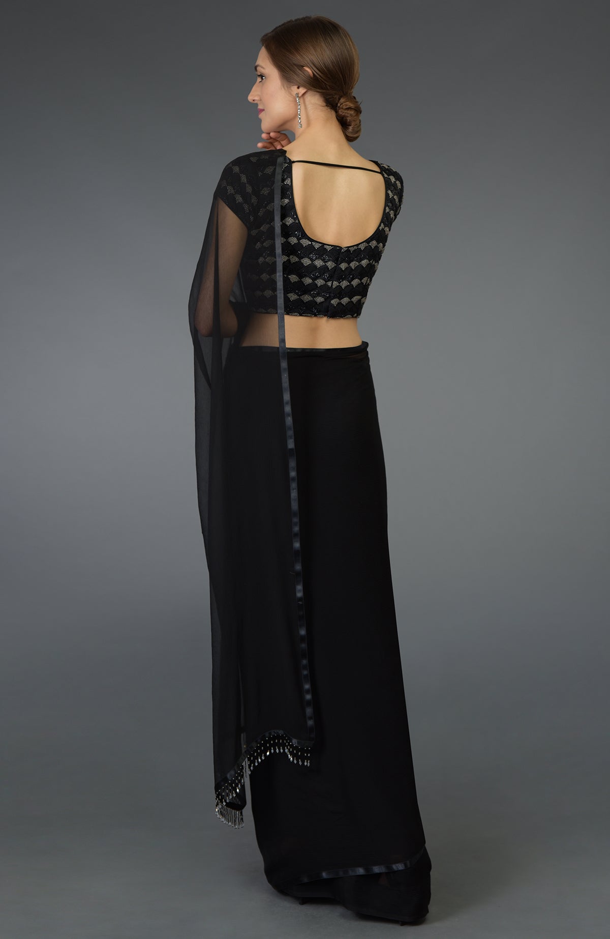 Black pure chiffon saree with a zardozi and beads work blouse.