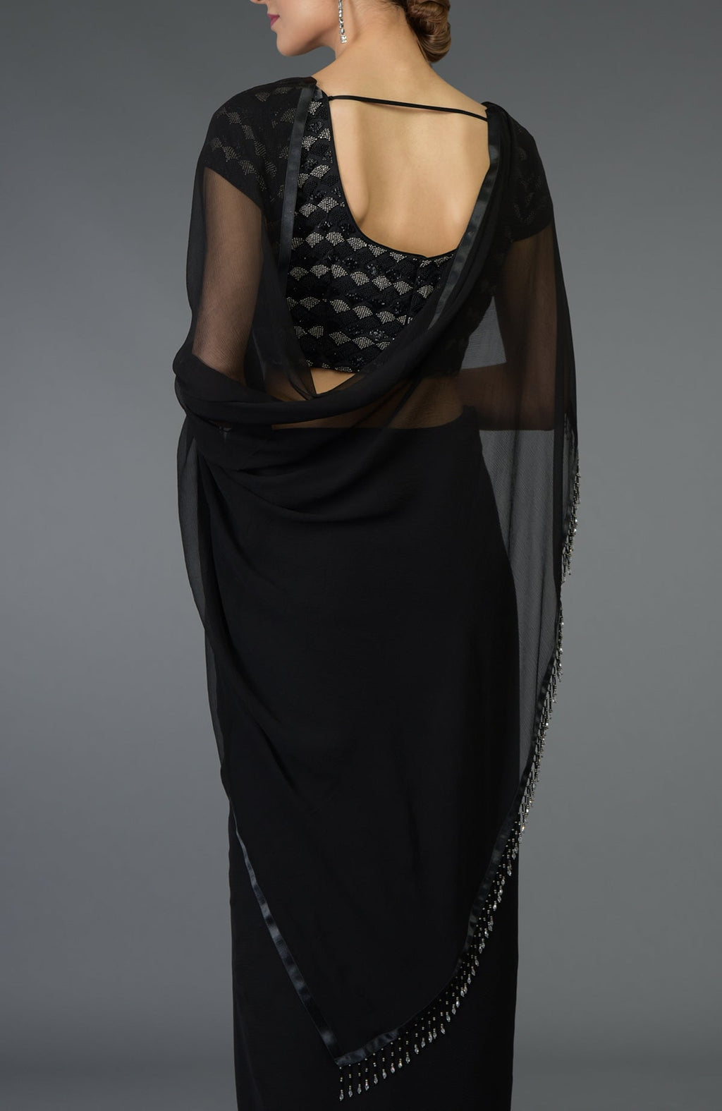 Black pure chiffon saree with a zardozi and beads work blouse.