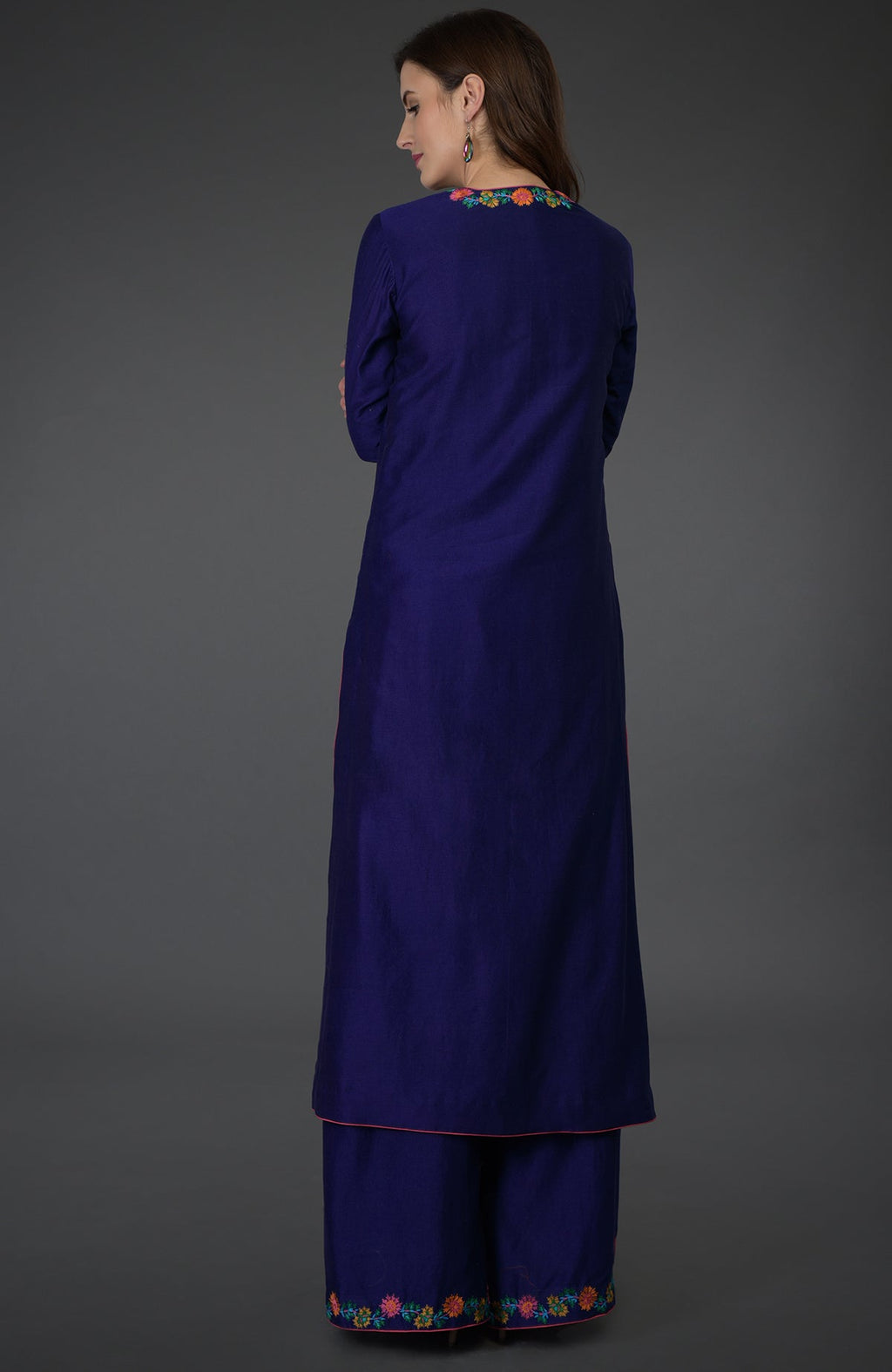 A woman models a Princess Blue Kashmir Bagh inspired Farshi Palazzo Suit.