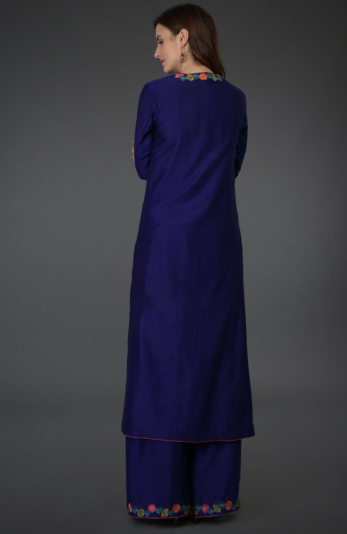 A woman models a Princess Blue Kashmir Bagh inspired Farshi Palazzo Suit.