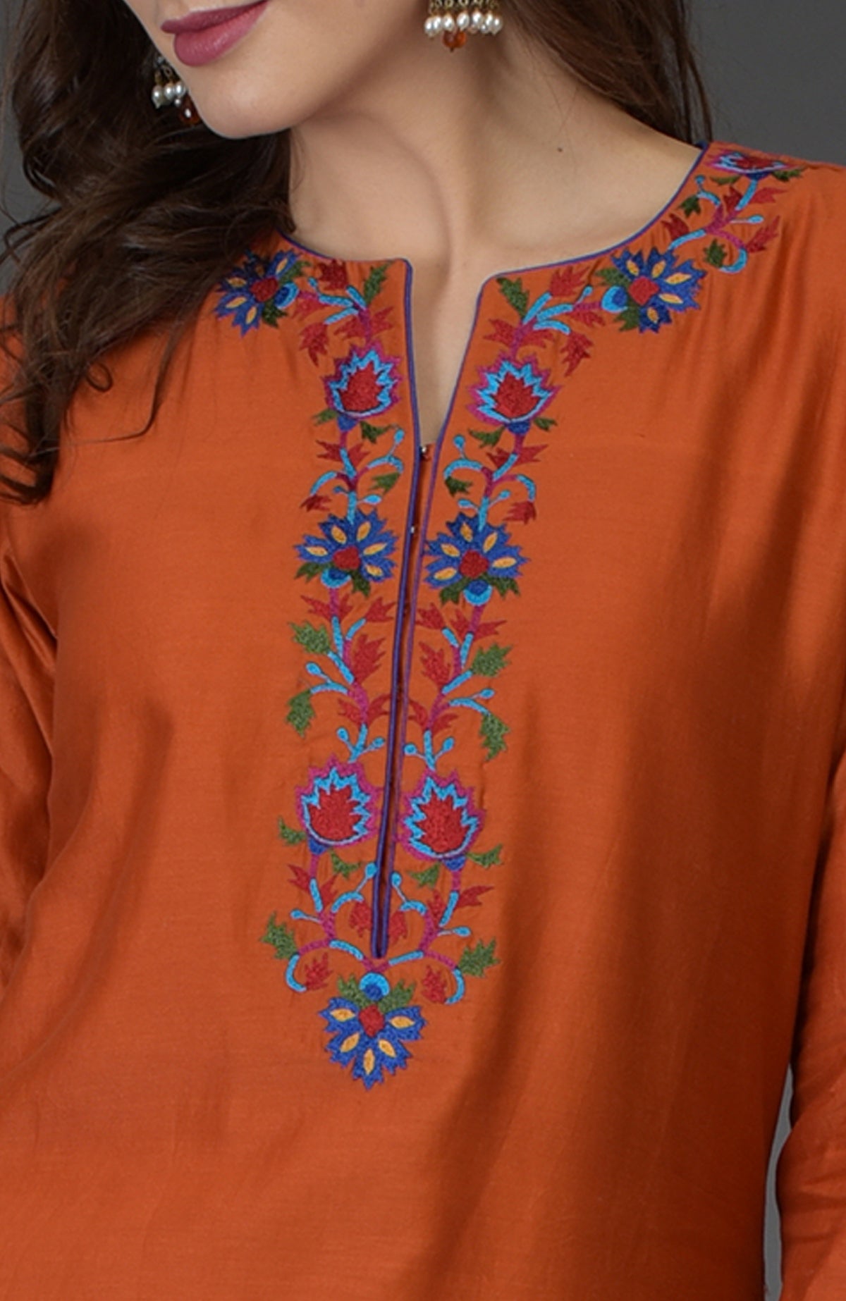 Burnt orange kurta with Kashmir Bagh inspired floral embroidery along the neckline.