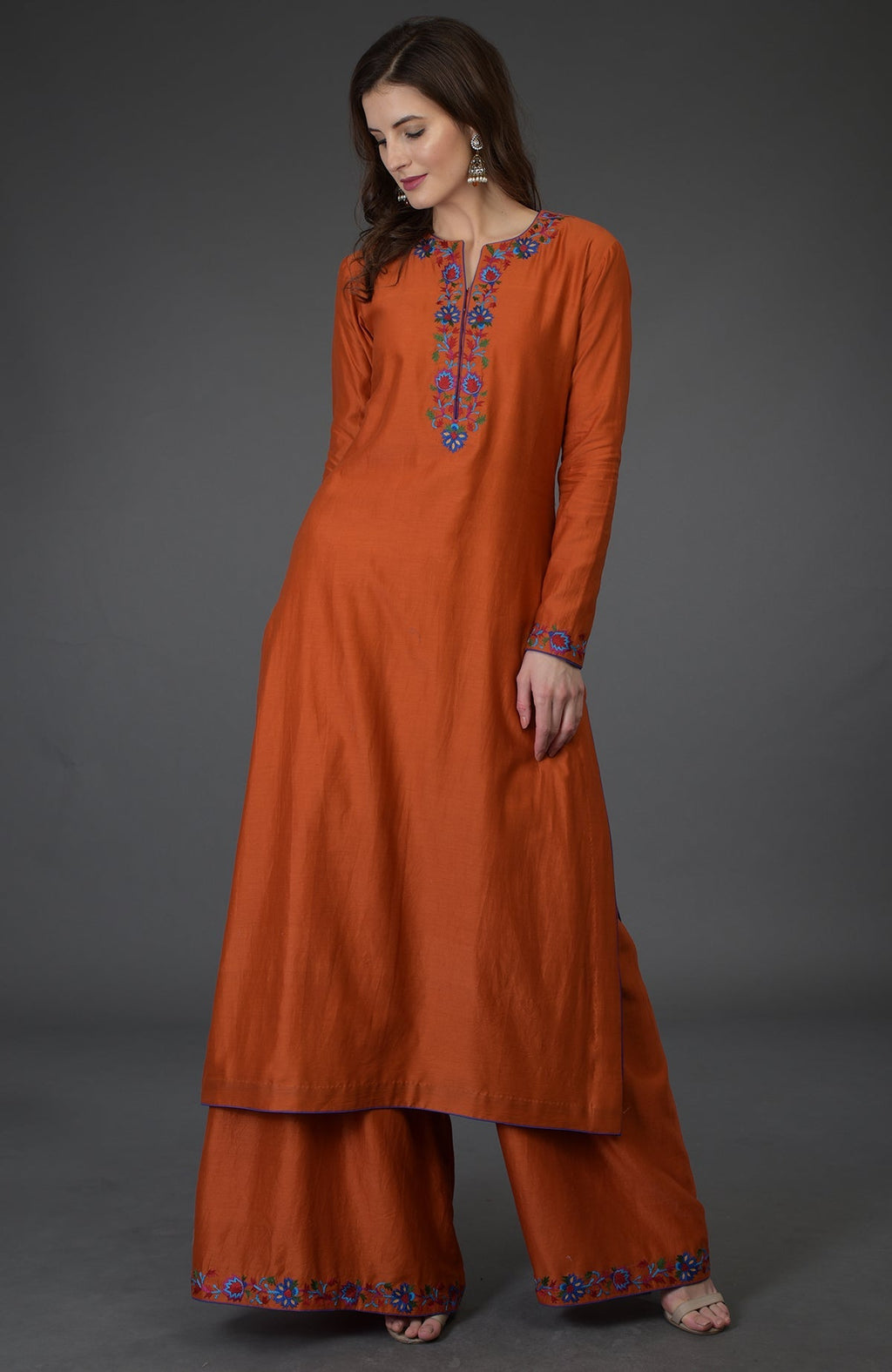 Burnt orange Kashmir Bagh inspired Farshi Palazzo suit with floral embroidery.
