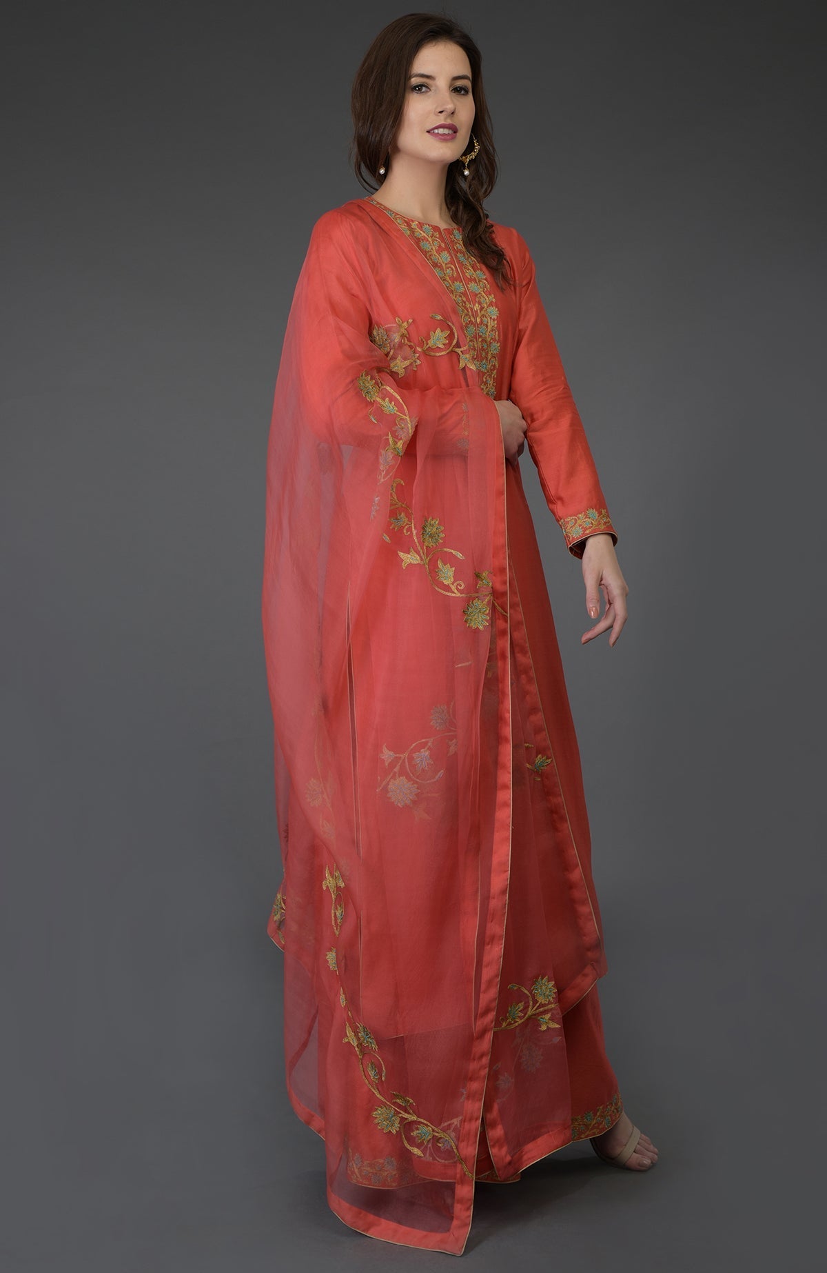 Living coral resham-tilla embroidered farshi palazzo suit with a matching dupatta.