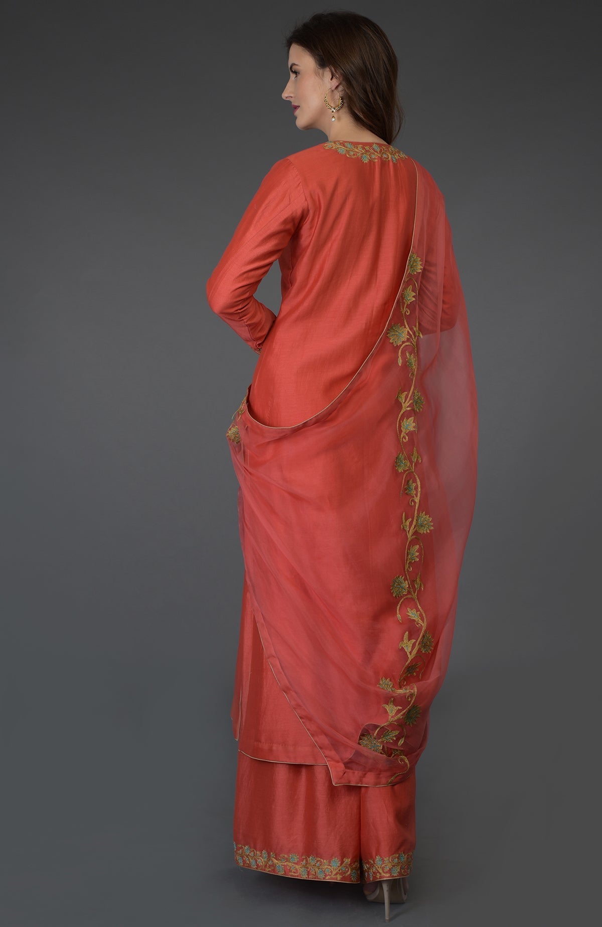 Living coral resham-tilla embroidered farshi palazzo suit with a sheer dupatta.