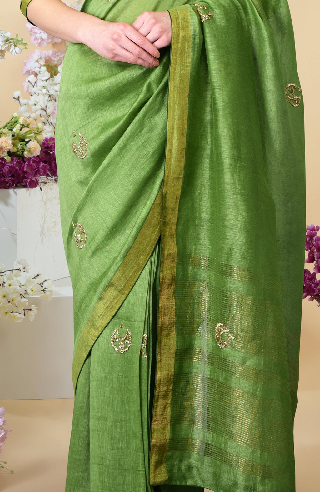 Pepper stem linen saree with zardozi hand embroidered motifs and zari weave borders.