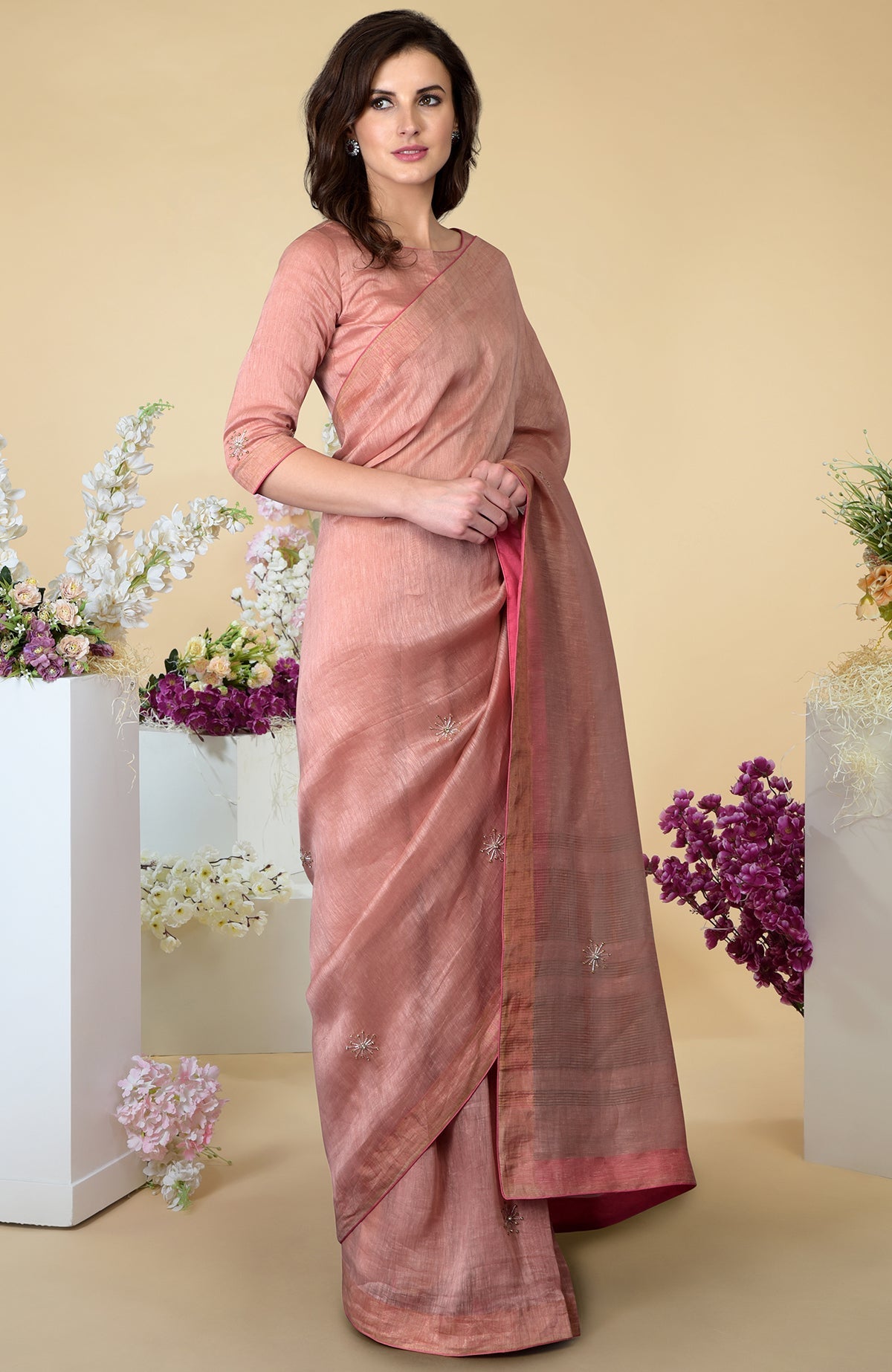 Pressed rose silk linen saree with zardozi hand embroidery and zari weave borders.
