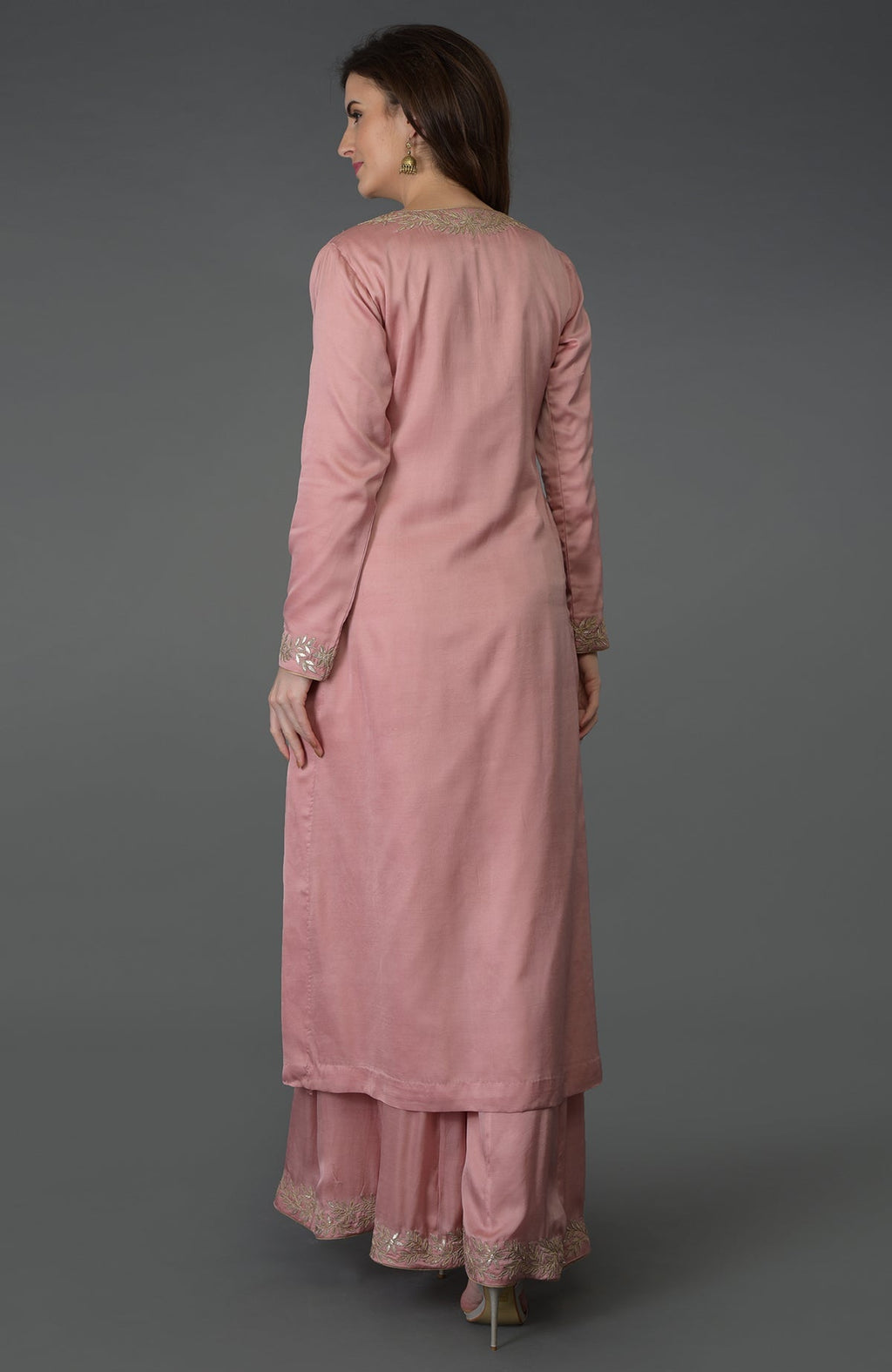 A woman models a pearl pink gota patti work farshi palazzo suit.