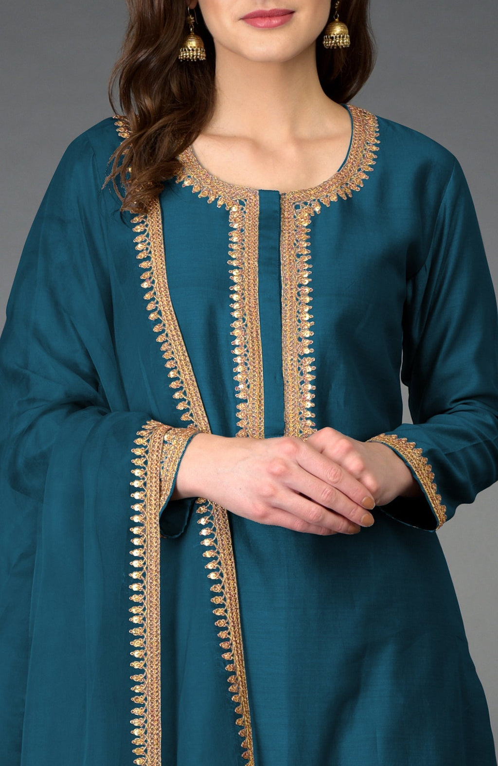 A woman models a peacock blue Marori and sequin work Farshi Palazzo Suit.