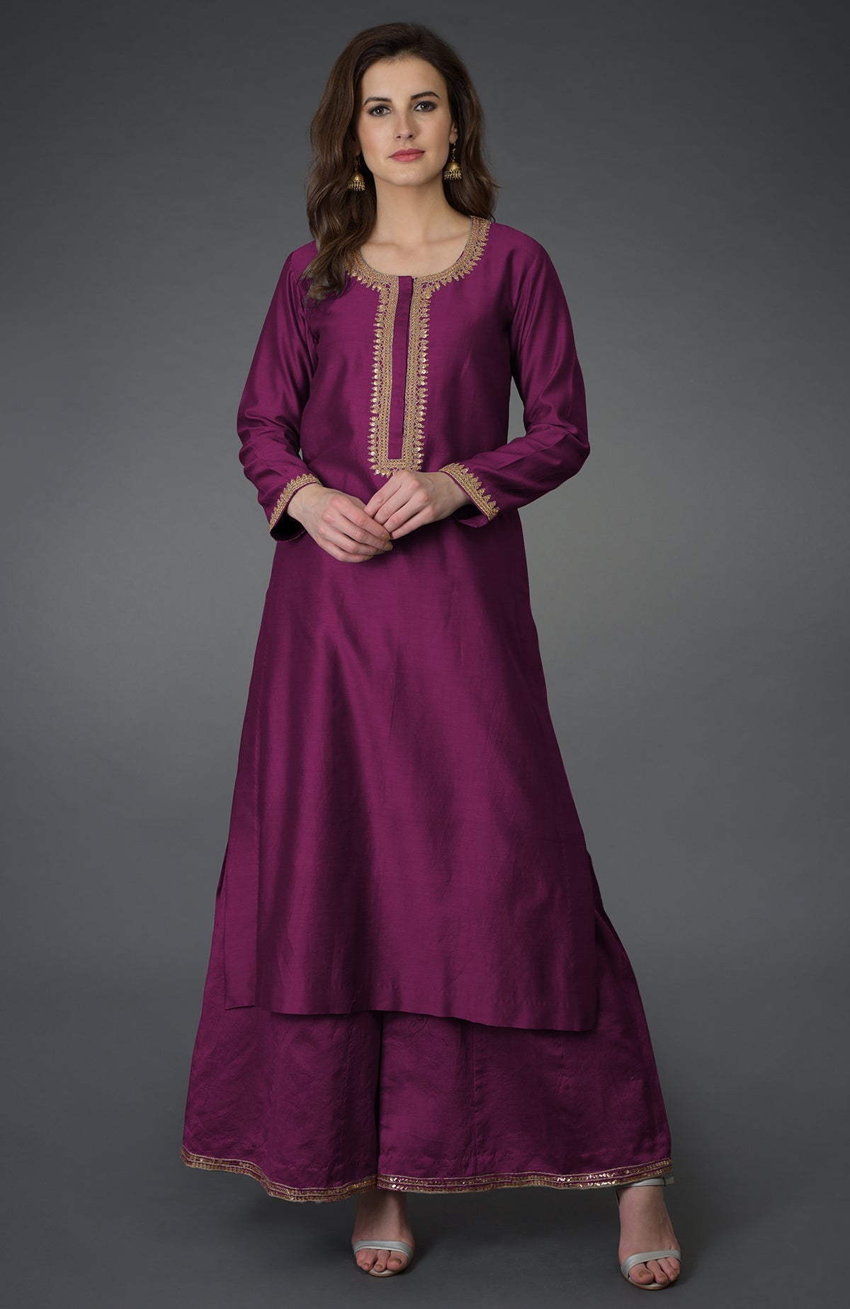 A woman models a peacock pink marori and sequin work farshi palazzo suit.