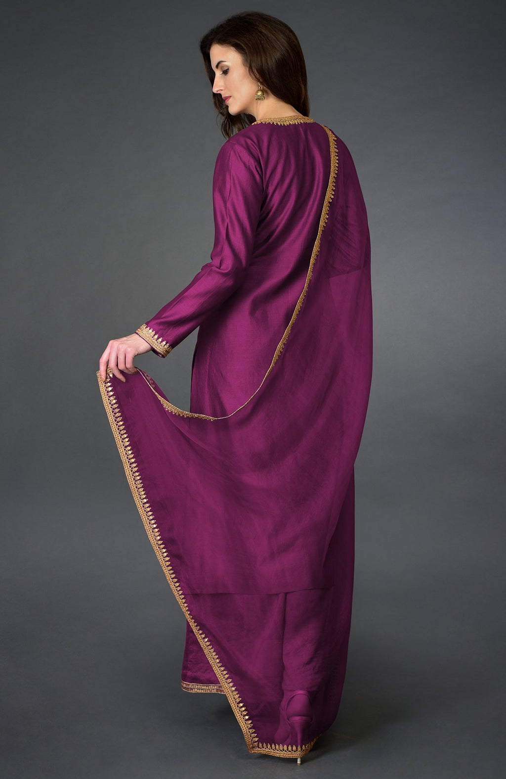 A woman models a peacock pink marori and sequin work farshi palazzo suit.