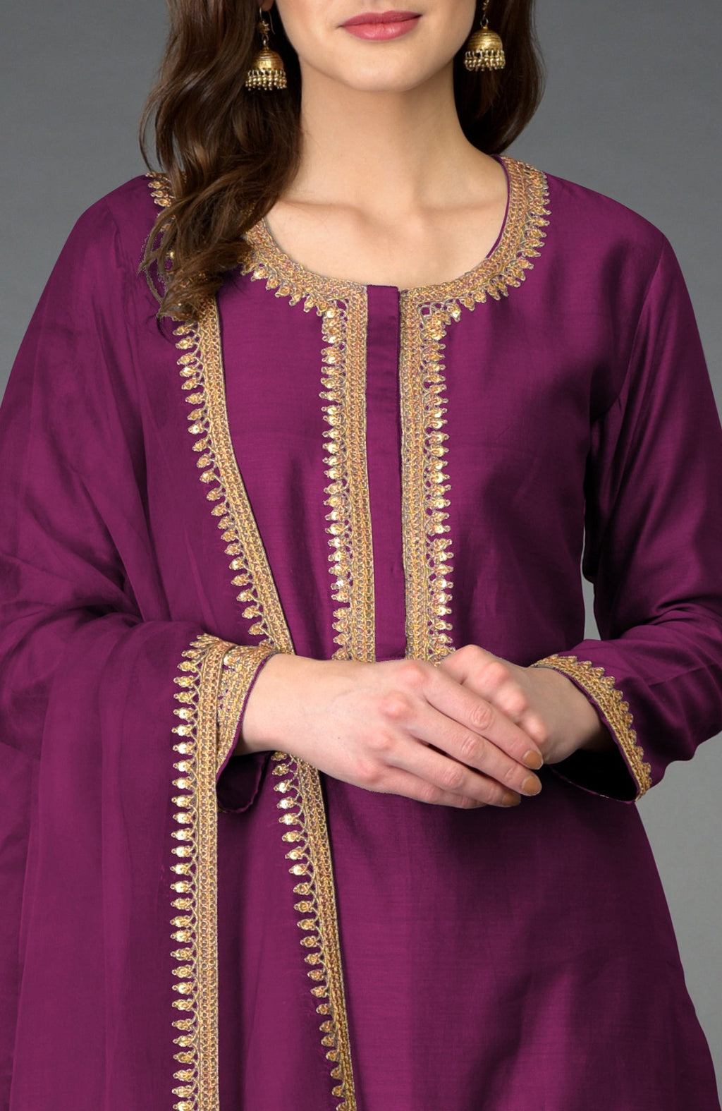 A woman models a peacock pink marori and sequin work farshi palazzo suit.