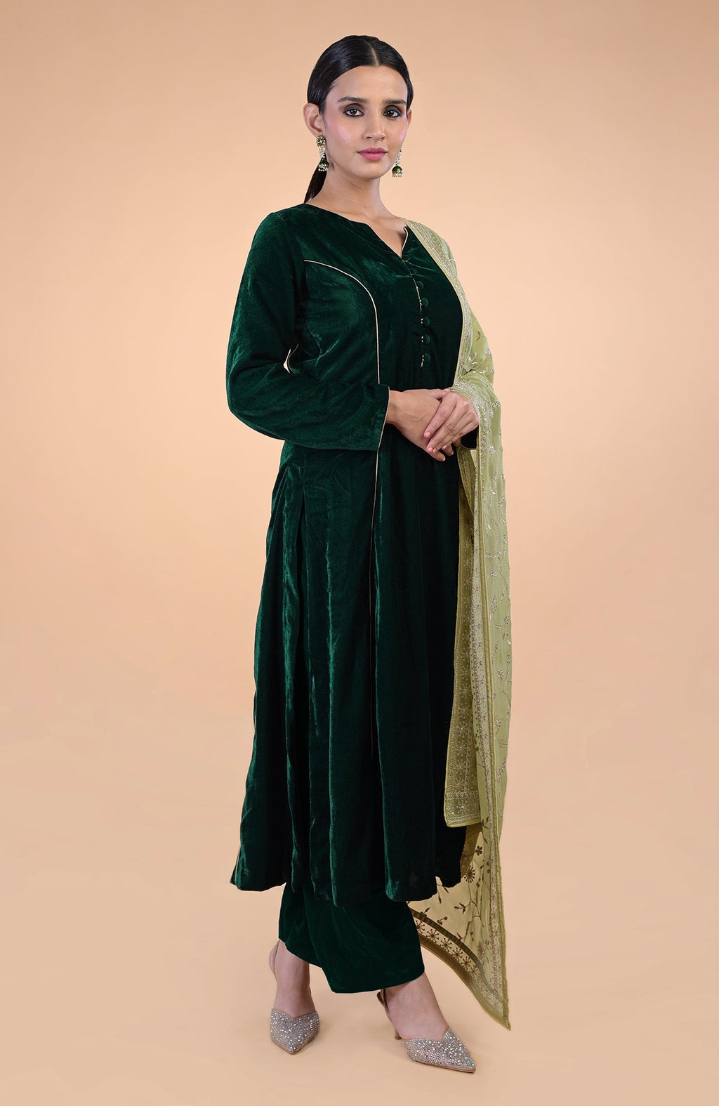 Bottle green velvet suit with a bog green floral zari and sequin embroidered dupatta.