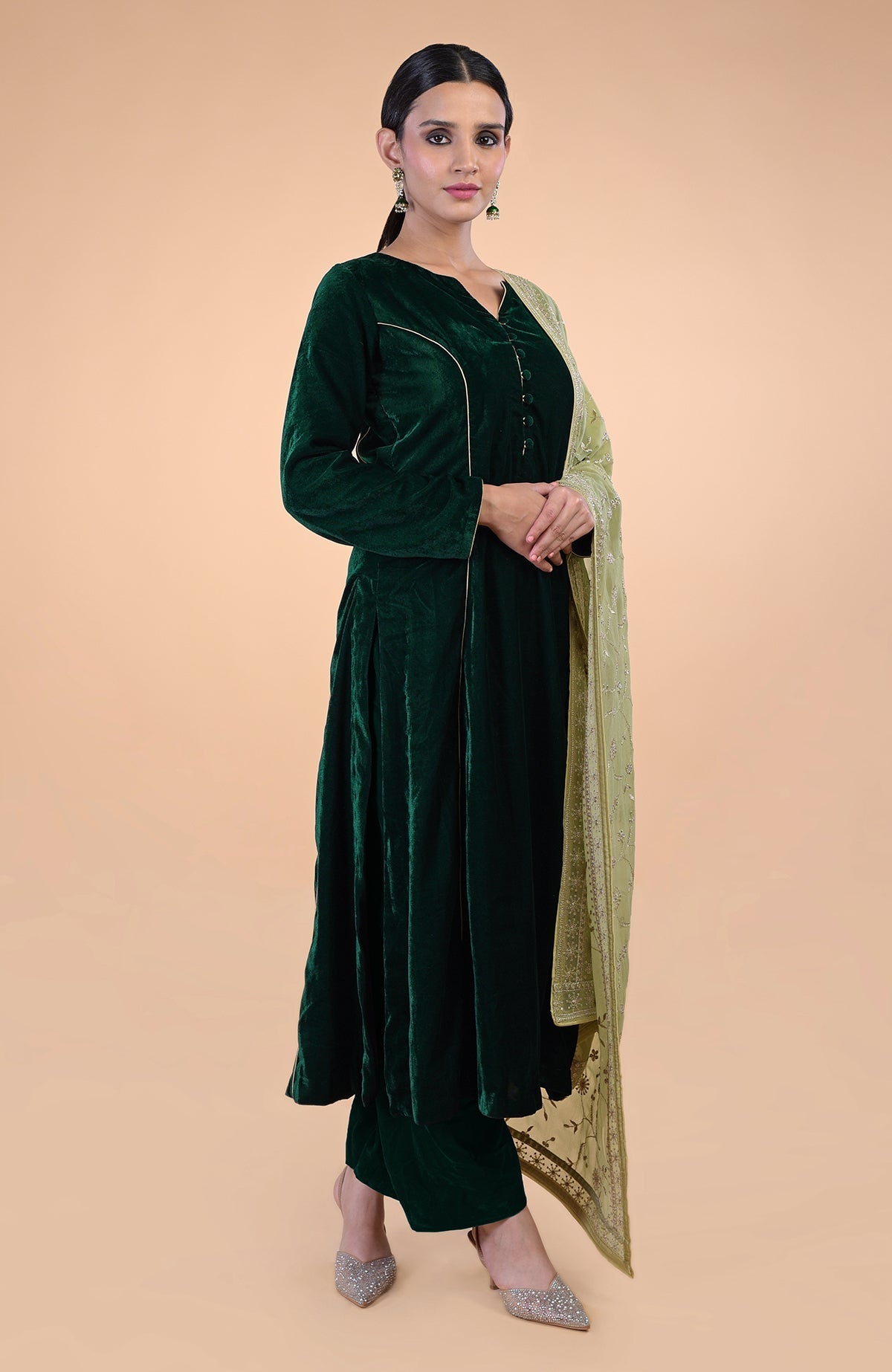 Bottle green velvet suit with a bog green floral zari and sequin embroidered dupatta.