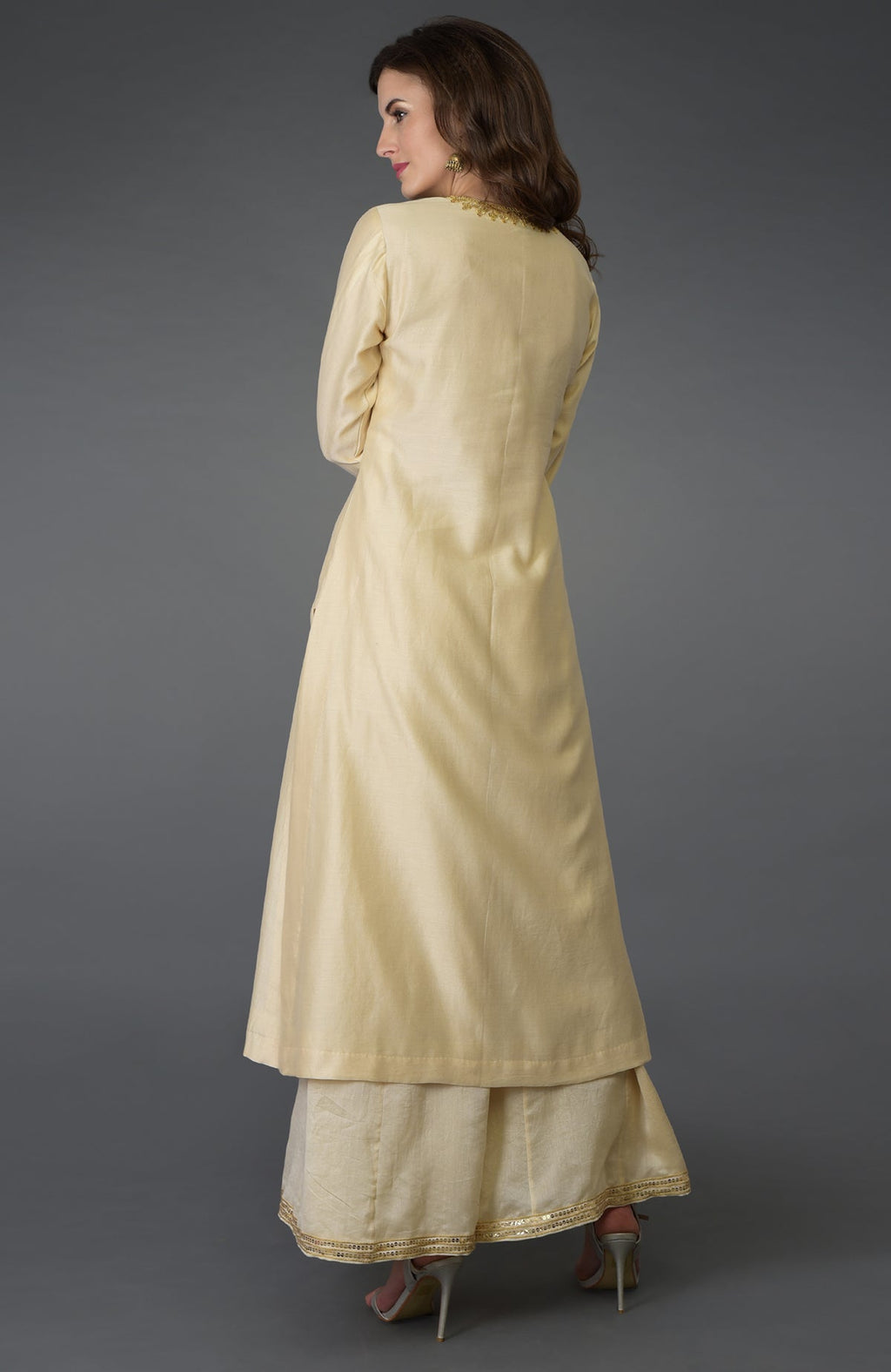 Woman in a cream marori and sequin work farshi palazzo suit.