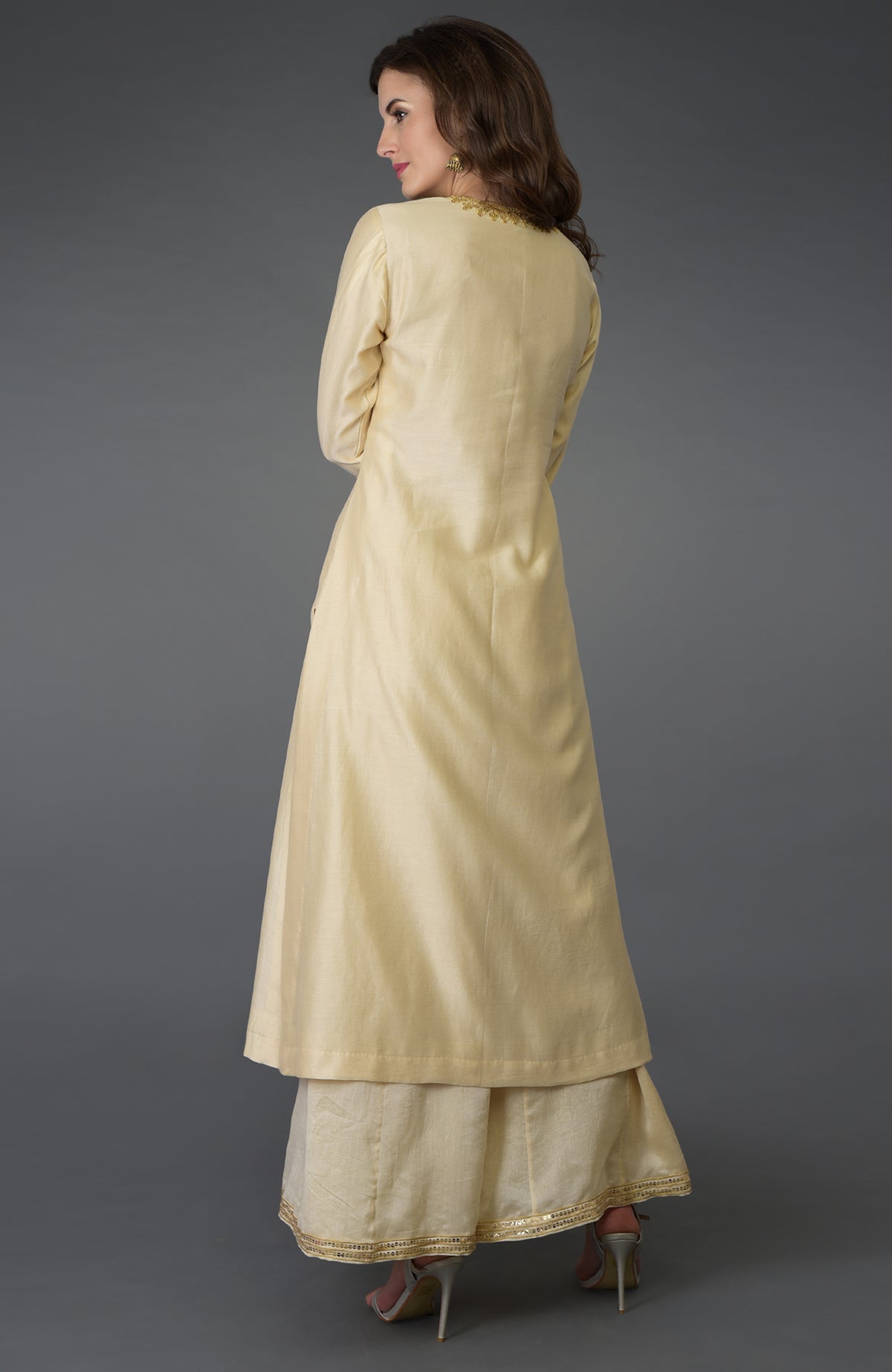 Woman in a cream marori and sequin work farshi palazzo suit.