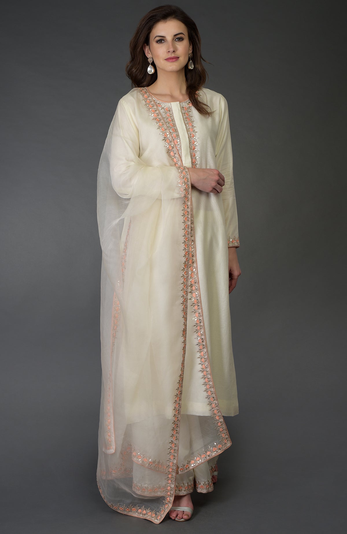 An ivory Resham Gota Patti and Pearl Beads Farshi Palazzo Suit.