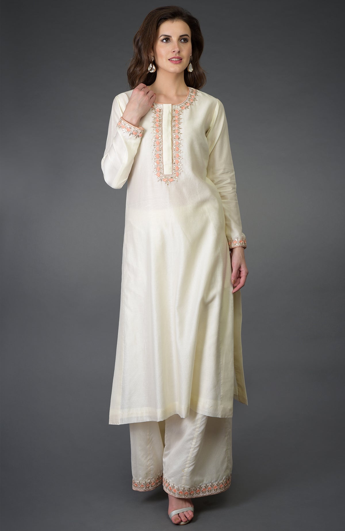 An ivory resham gota patti and pearl beads farshi palazzo suit.