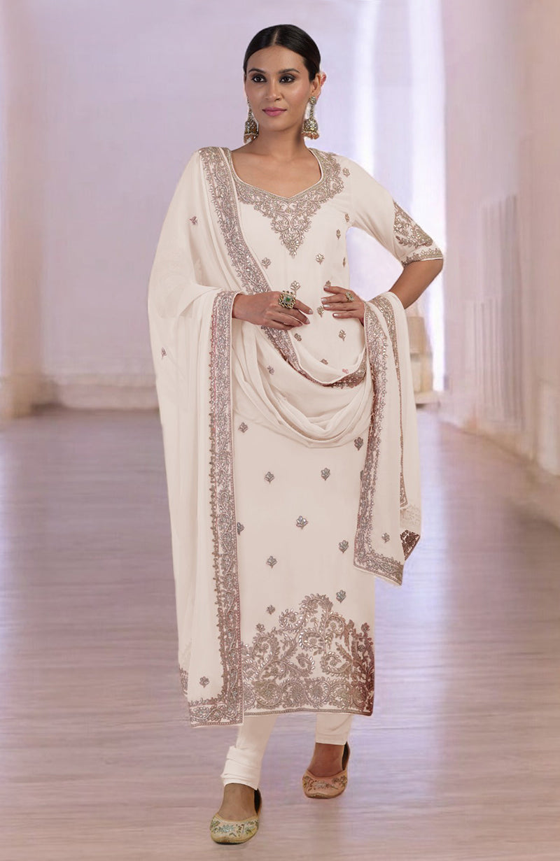 A woman models a sea salt kurta set with intricate rose gold embroidery.