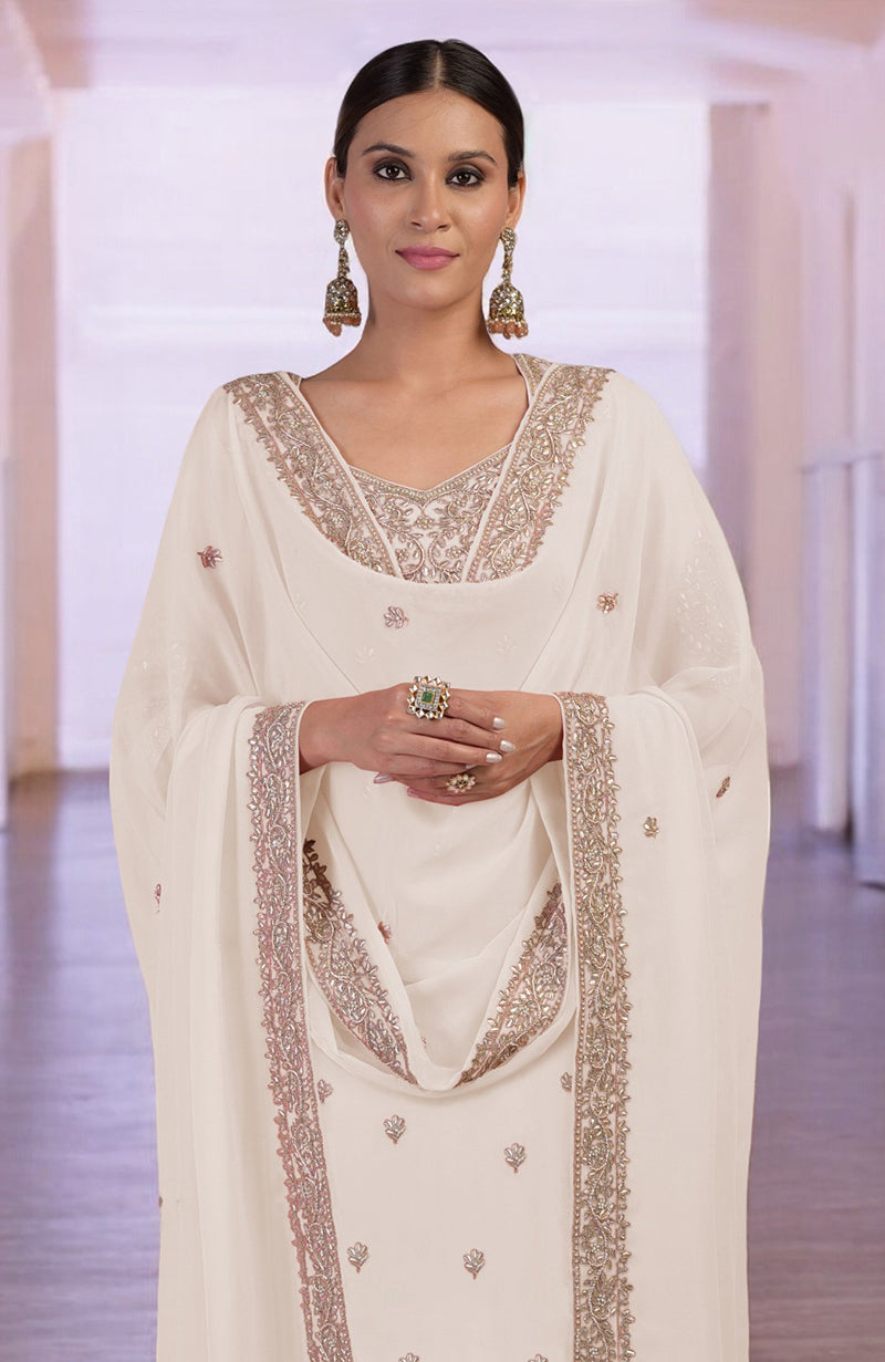 A woman models a sea salt kurta set with intricate rose gold embroidery.