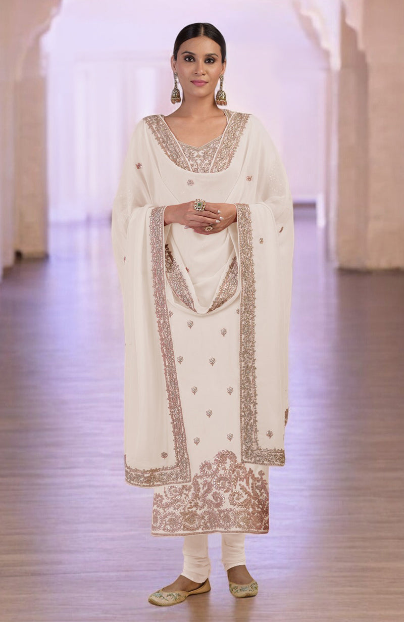 A woman models a sea salt kurta set with intricate rose gold embroidery.